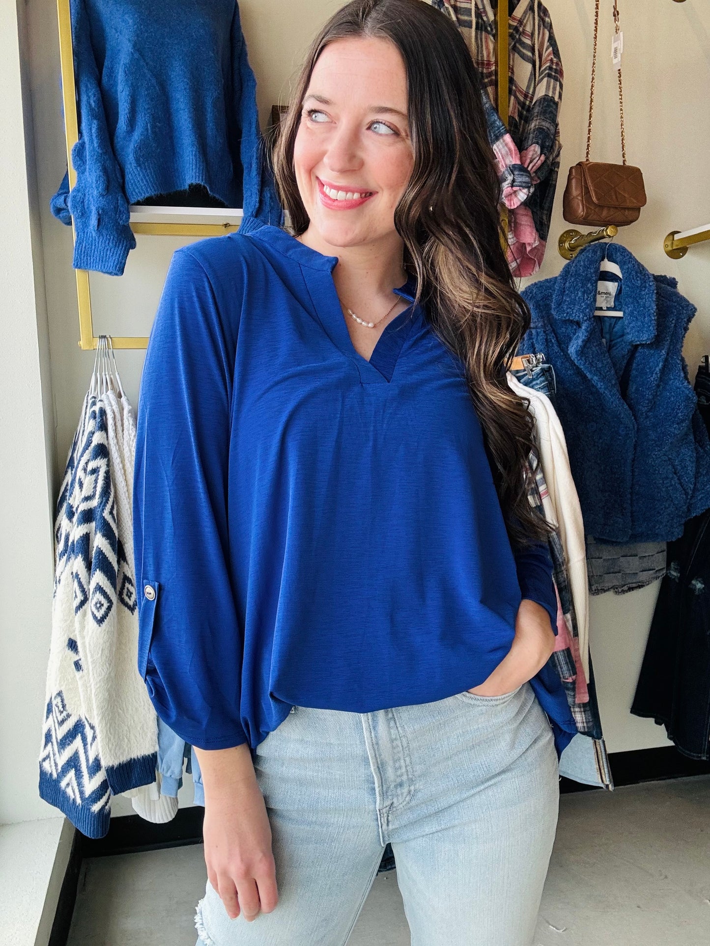 Our signature Lizzy Top is crafted from a soft, luxurious poly blend that offers lightweight, wrinkle-free comfort. Designed for easy care, this travel-friendly top is cooler than linen, making it the ultimate choice for life on the go. The Lizzy also features a mandarin collar neckline and 3/4" length sleeves with tab details. Its relaxed, flowy fit and subtle high-low hemline ensure a flattering silhouette for any occasion.