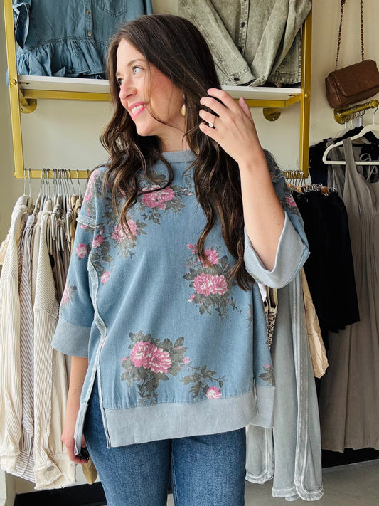 Bibi
This playful denim top features half sleeves and a classic crewneck, perfect for casual days with a twist. The exposed seams add a trendy edge, while side slits ensure comfort and ease of movement. Adorned with a beautiful floral design, it brings a fresh, fun vibe to your wardrobe.