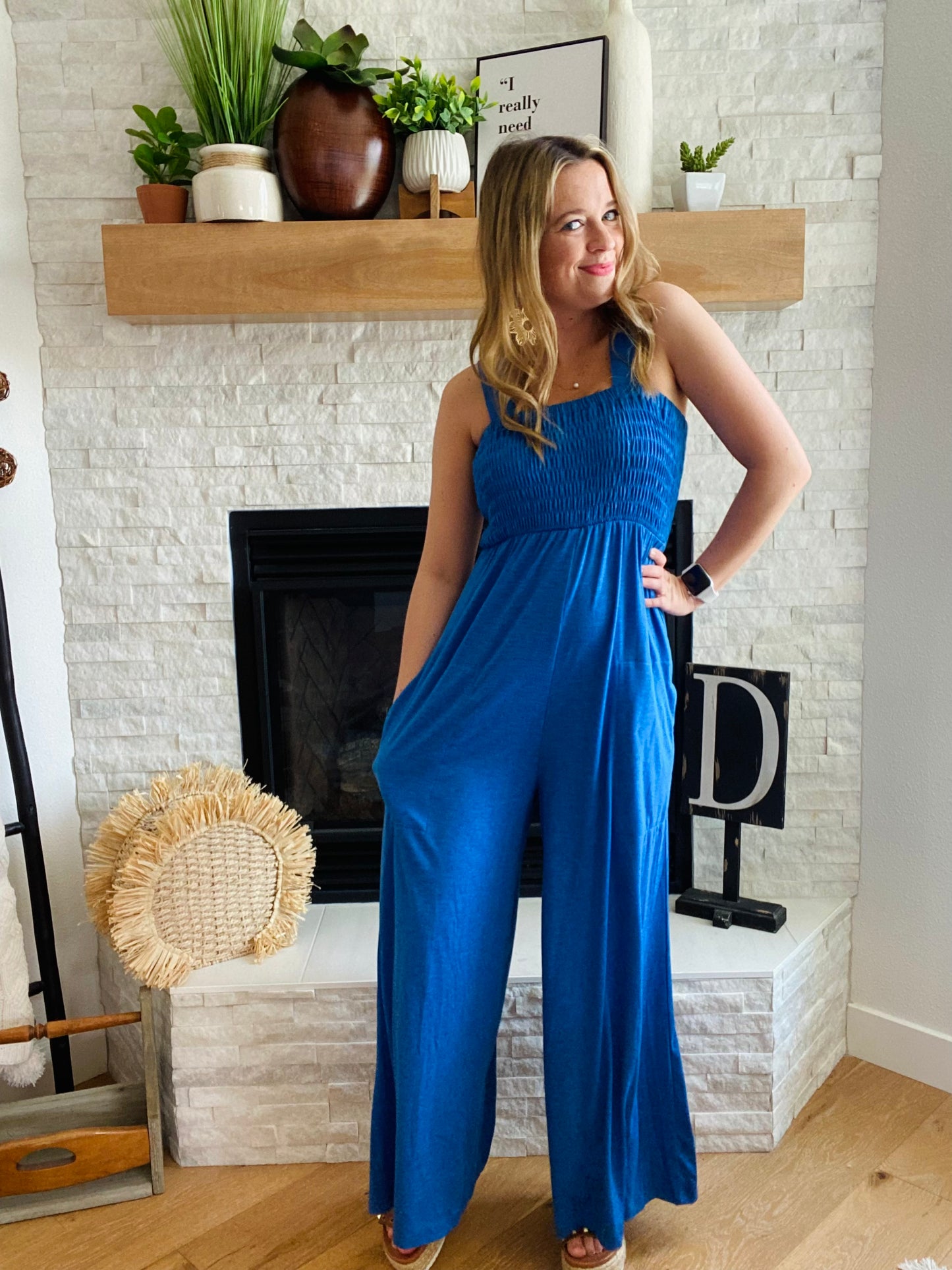 Make a statement in this eye-catching smocked jumpsuit! This chic, deep blue one-piece has a surprisingly stretchy material, comfortable enough for all-day wear. Say goodbye to jeans and welcome this wide-leg stunner with stylish smocked detailing!