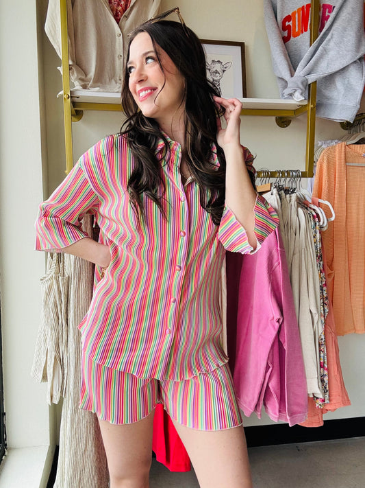 Jess Lea
Get ready for a dreamy day in our Dreamy Daze Pleated Set! This fun and colorful set features half sleeves, lettuce hemlines, and a button up design with an elastic waistband for a comfortable fit. Perfect for a playful and stylish look.