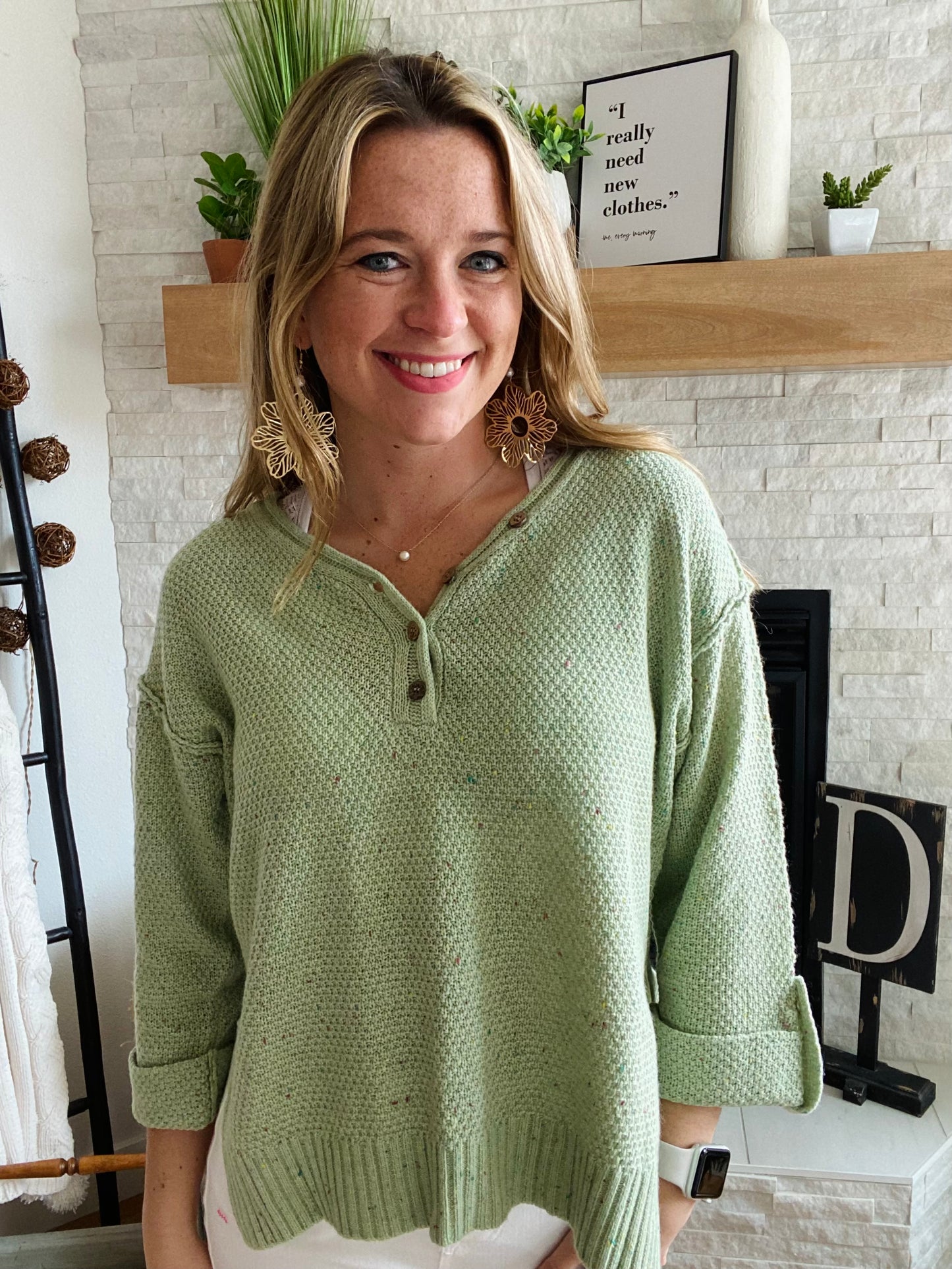 Our Green Button Confetti Sweater is the perfect statement piece this season. It features striking flecks of color in the fabric, a rolled up sleeve with button detailing, and a slightly oversized fit. With a versatile design, this sweater pairs easily with white denim for a unique, stylistic look.