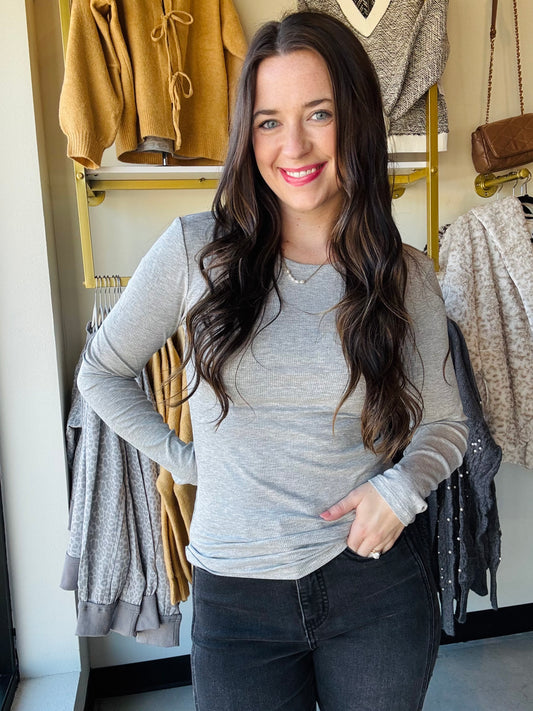 Yelete 
Cozy meets cute in this Heather Grey Viscose Long Sleeve tee. Its soft, breathable fabric keeps you comfy all day, while the classic crew neckline adds just the right touch of charm. The fitted silhouette hugs your shape for a flattering look, and those long sleeves are perfect for chillier days or layering fun. 