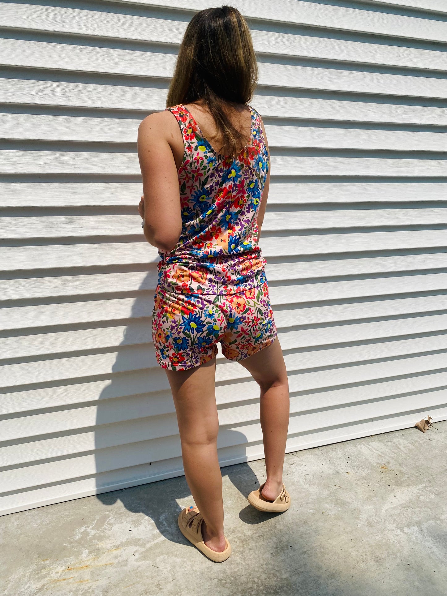 Stay stylish and comfortable all summer in the Vibrant Garden Floral Lounge Set. This set features a scoop neck tank top and drawstring comfy shorts in bright colors - perfect for lounging around going out and about.. Shhh we won't tell! The lightweight fabric keeps you cool in the heat, while the stylish design ensures you look great even at home!