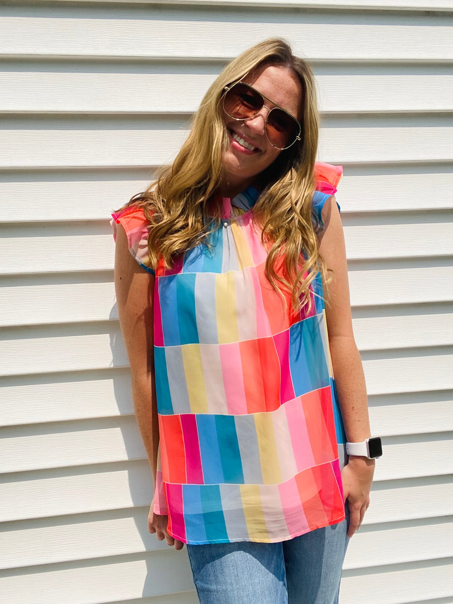 This Color Wheel Ruffle Blouse is the perfect office essential for the summer season. Crafted with bright, vibrant colors, the trendy high neckline and key hole closure provide an updated classic silhouette. The perfect match for any summer ensemble.