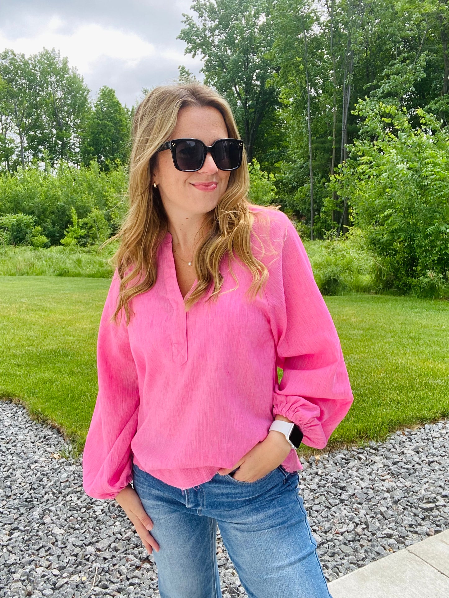Introducing the Bubblegum Pink Woven Gauze Blouse, a stylish piece featuring V Neck Placket with Snap Closure, Raw Cut Edge Hem with Facing, Raglan Cut Bubble Sleeves, Gathered Neckline, Elasticized Wrists, and a Banded Collar. This garment is crafted with superior materials for a comfortable, timeless look.