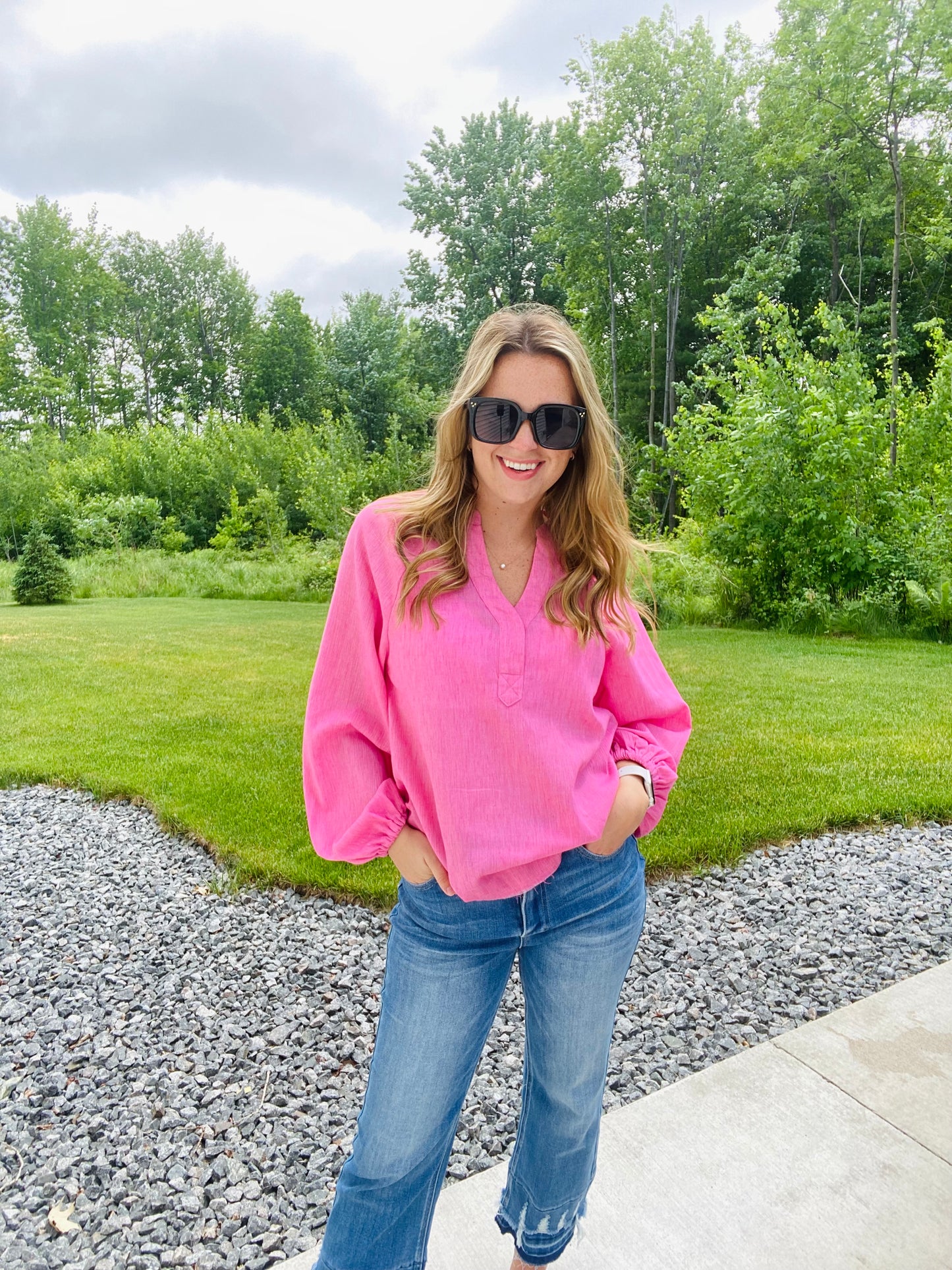 Introducing the Bubblegum Pink Woven Gauze Blouse, a stylish piece featuring V Neck Placket with Snap Closure, Raw Cut Edge Hem with Facing, Raglan Cut Bubble Sleeves, Gathered Neckline, Elasticized Wrists, and a Banded Collar. This garment is crafted with superior materials for a comfortable, timeless look.