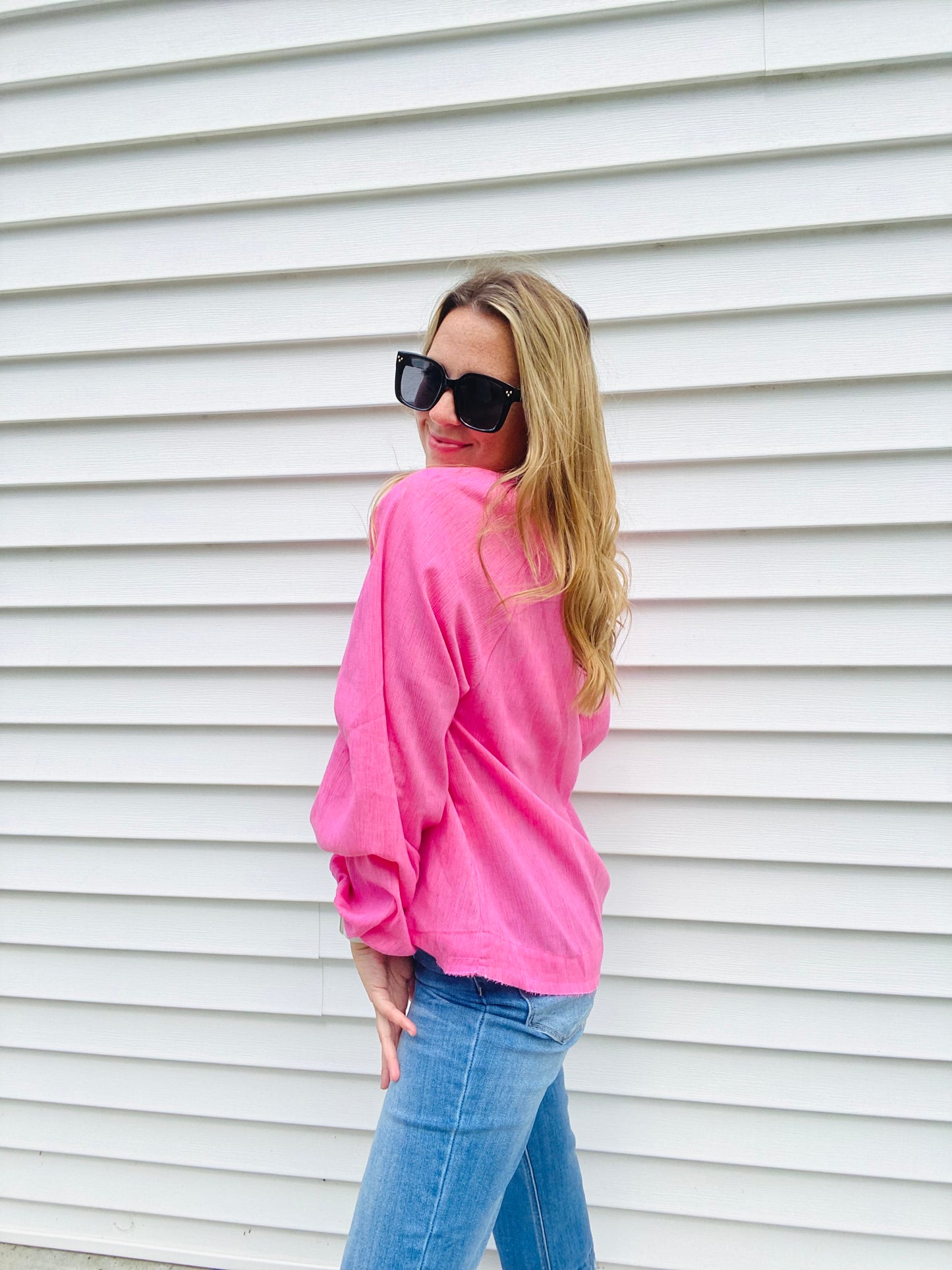 Introducing the Bubblegum Pink Woven Gauze Blouse, a stylish piece featuring V Neck Placket with Snap Closure, Raw Cut Edge Hem with Facing, Raglan Cut Bubble Sleeves, Gathered Neckline, Elasticized Wrists, and a Banded Collar. This garment is crafted with superior materials for a comfortable, timeless look.