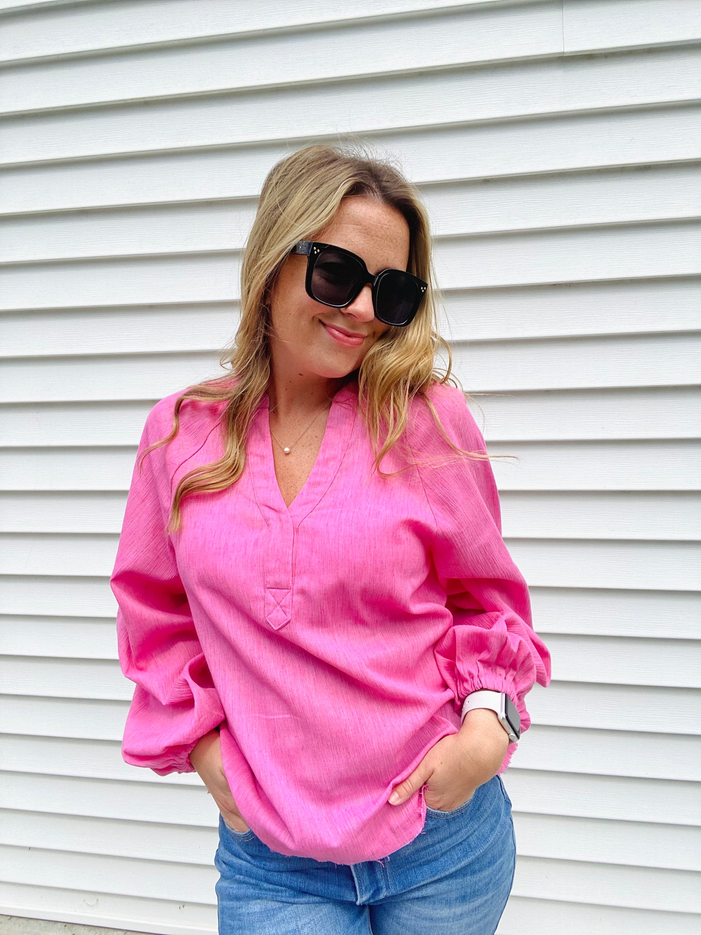 Introducing the Bubblegum Pink Woven Gauze Blouse, a stylish piece featuring V Neck Placket with Snap Closure, Raw Cut Edge Hem with Facing, Raglan Cut Bubble Sleeves, Gathered Neckline, Elasticized Wrists, and a Banded Collar. This garment is crafted with superior materials for a comfortable, timeless look.