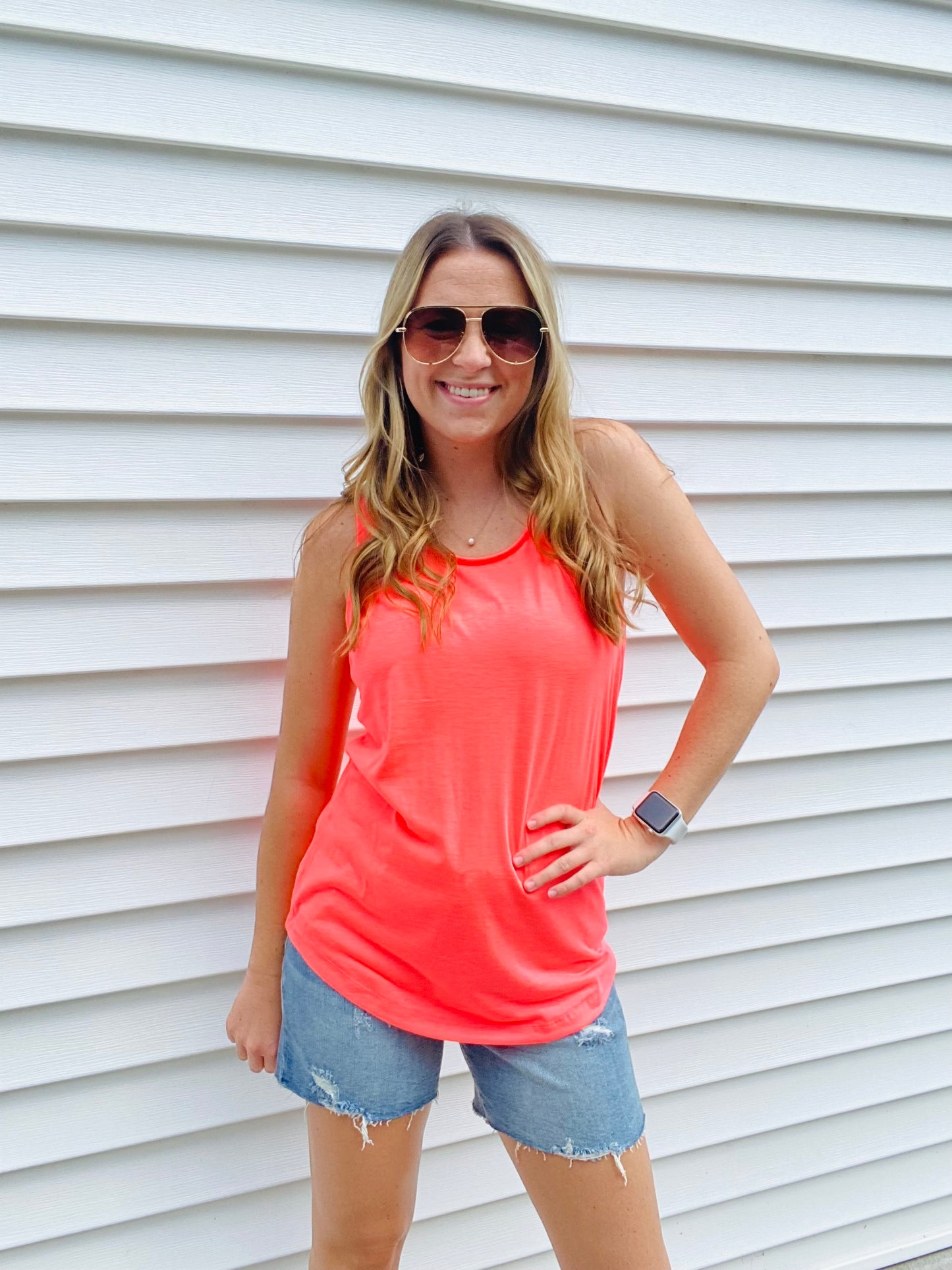 The Neon Coral Tiffany Tank is the perfect combination of comfy and trendy. Crafted with a stretchy fabric for ultimate comfort, this tank features a scoop neck and wide straps to ensure a secure fit and bold neon colors to make a statement. Feel fashionable and secure with this essential tank.