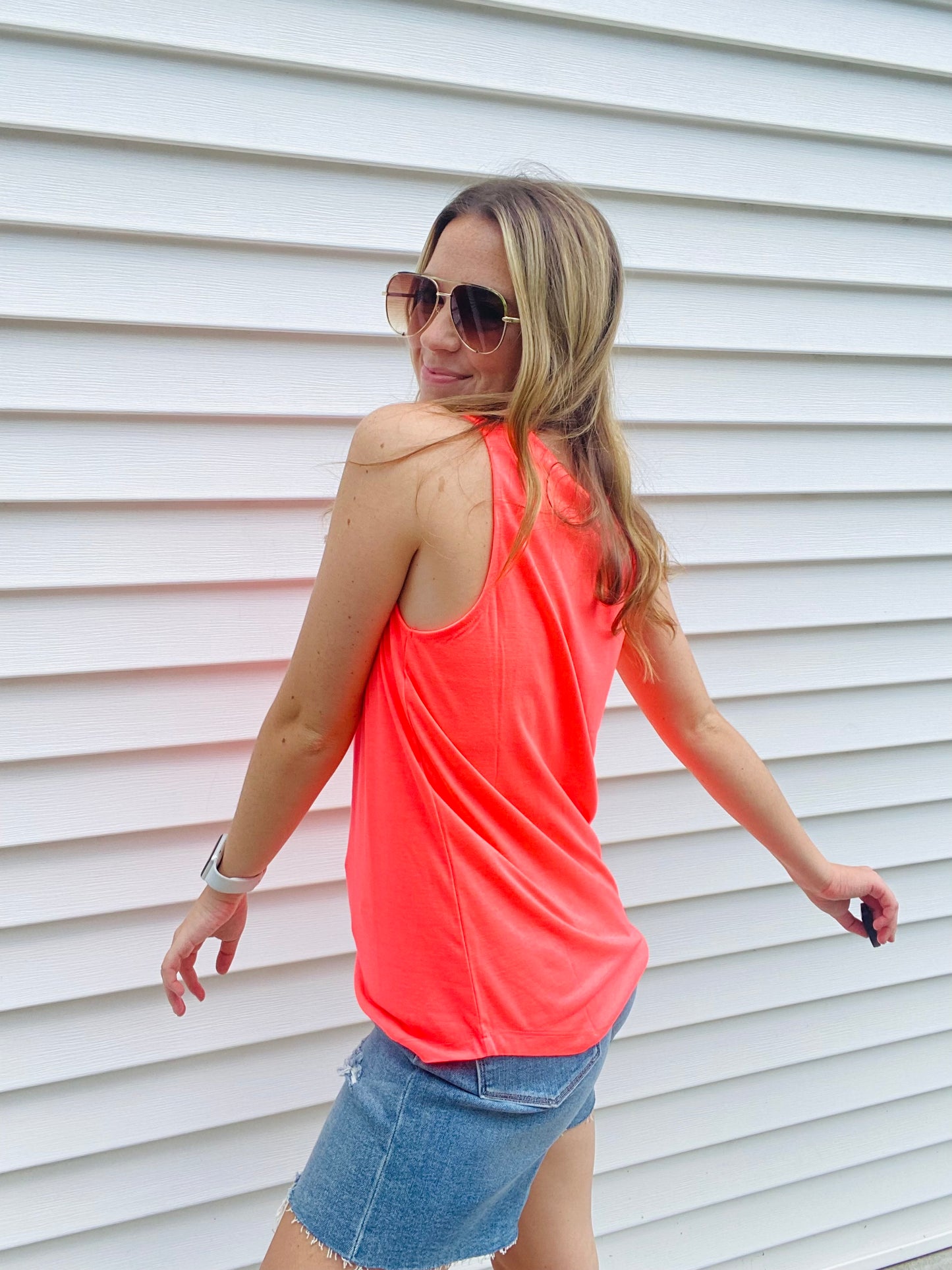 The Neon Coral Tiffany Tank is the perfect combination of comfy and trendy. Crafted with a stretchy fabric for ultimate comfort, this tank features a scoop neck and wide straps to ensure a secure fit and bold neon colors to make a statement. Feel fashionable and secure with this essential tank.