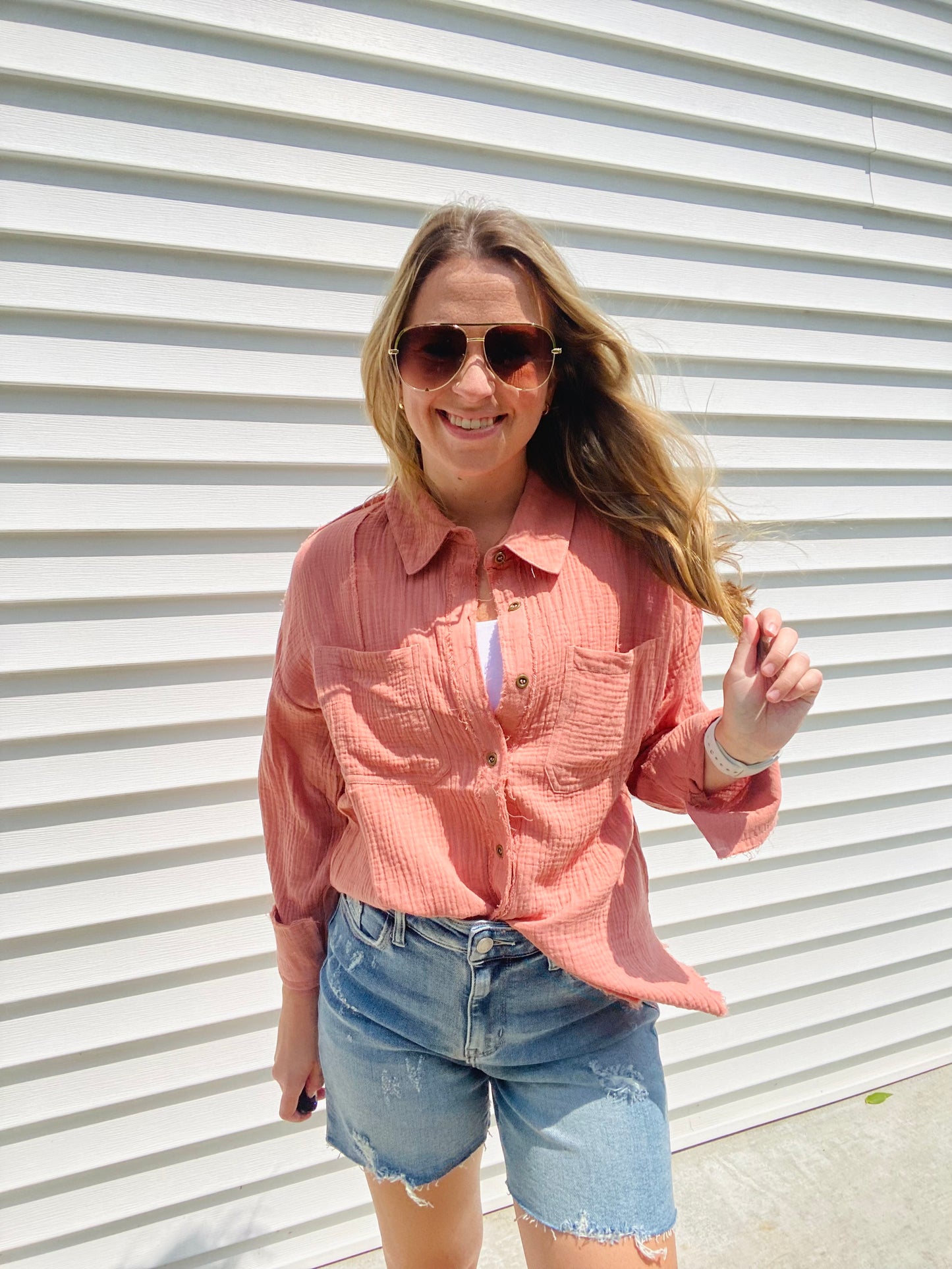This Frayed Hem Woven Top is perfect for the fashion-forward individual. This long-sleeved woven top features a frayed hem detail, button down closure, and a front pocket patched for a stylish, yet comfortable look. With its modern design and subtle colors, this top is sure to be a timeless addition to your wardrobe.