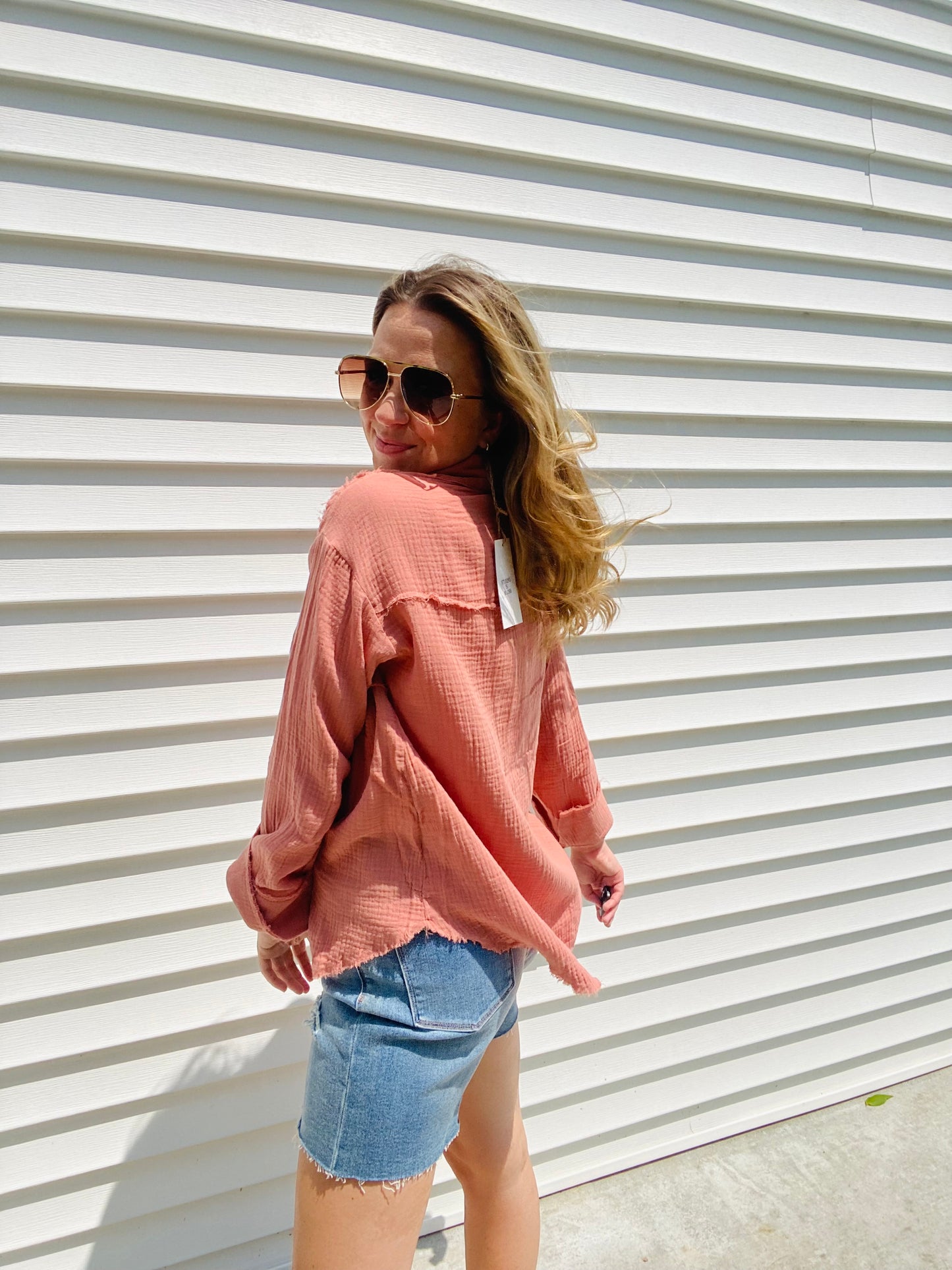 This Frayed Hem Woven Top is perfect for the fashion-forward individual. This long-sleeved woven top features a frayed hem detail, button down closure, and a front pocket patched for a stylish, yet comfortable look. With its modern design and subtle colors, this top is sure to be a timeless addition to your wardrobe.