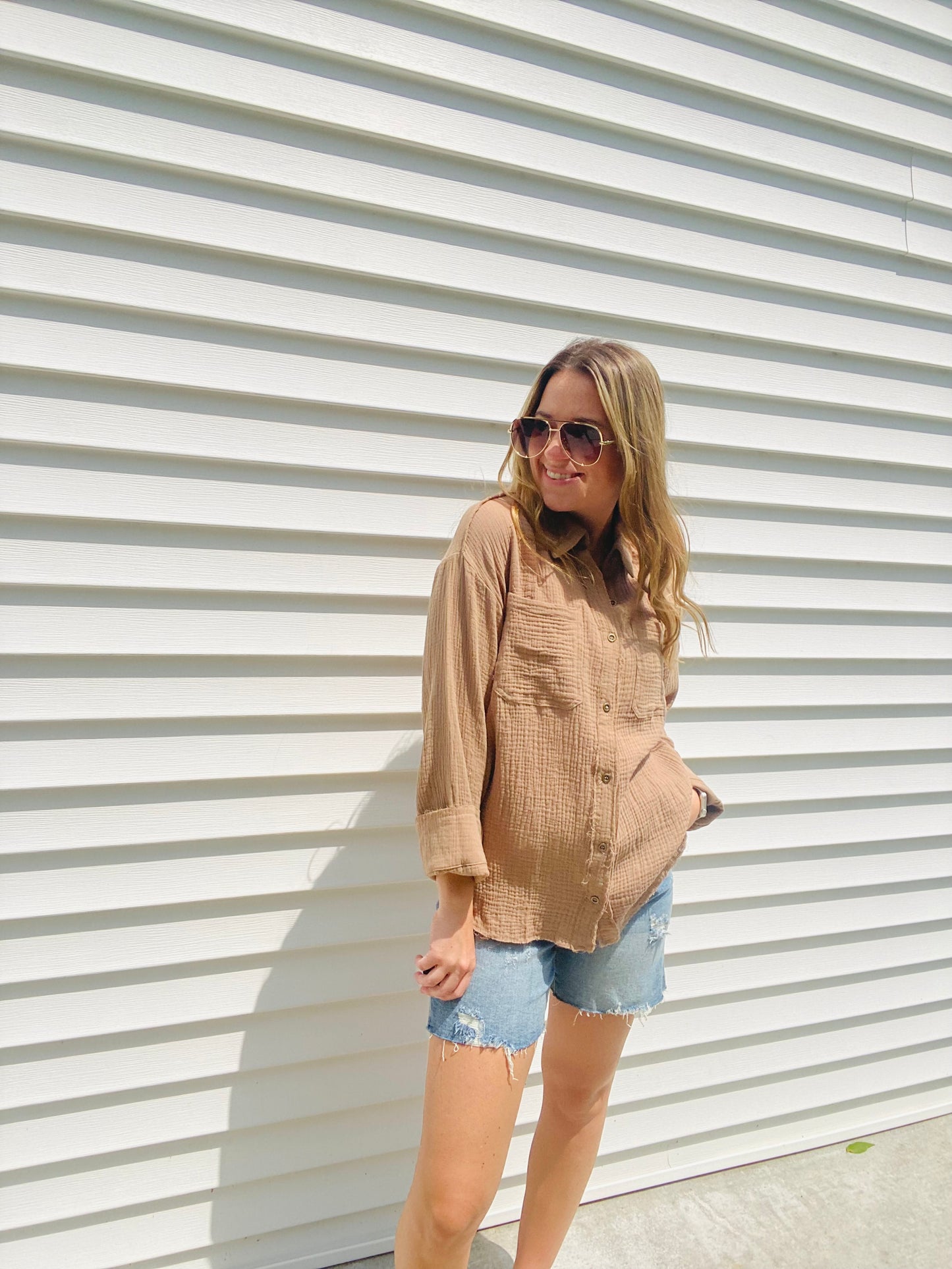 This Frayed Hem Woven Top is perfect for the fashion-forward individual. This long-sleeved woven top features a frayed hem detail, button down closure, and a front pocket patched for a stylish, yet comfortable look. With its modern design and subtle colors, this top is sure to be a timeless addition to your wardrobe.