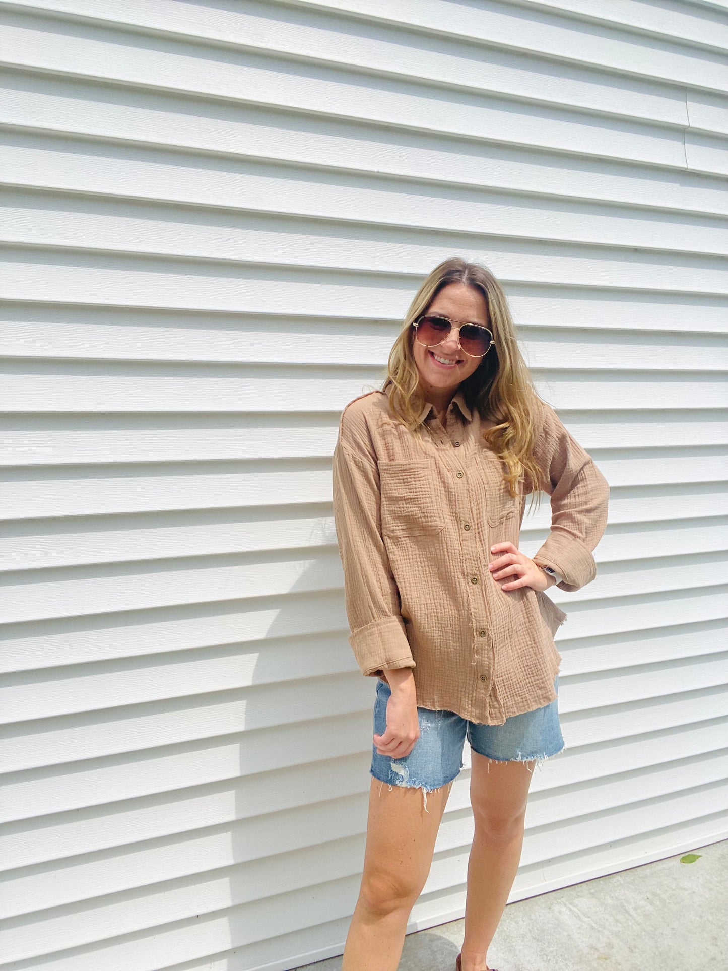 This Frayed Hem Woven Top is perfect for the fashion-forward individual. This long-sleeved woven top features a frayed hem detail, button down closure, and a front pocket patched for a stylish, yet comfortable look. With its modern design and subtle colors, this top is sure to be a timeless addition to your wardrobe.