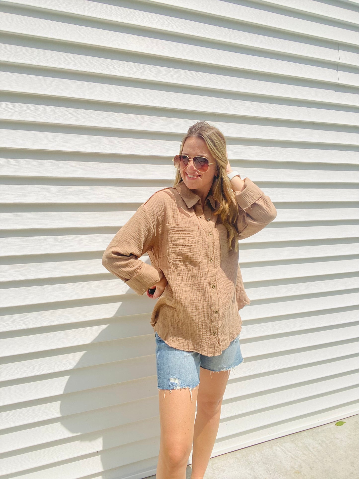 This Frayed Hem Woven Top is perfect for the fashion-forward individual. This long-sleeved woven top features a frayed hem detail, button down closure, and a front pocket patched for a stylish, yet comfortable look. With its modern design and subtle colors, this top is sure to be a timeless addition to your wardrobe.