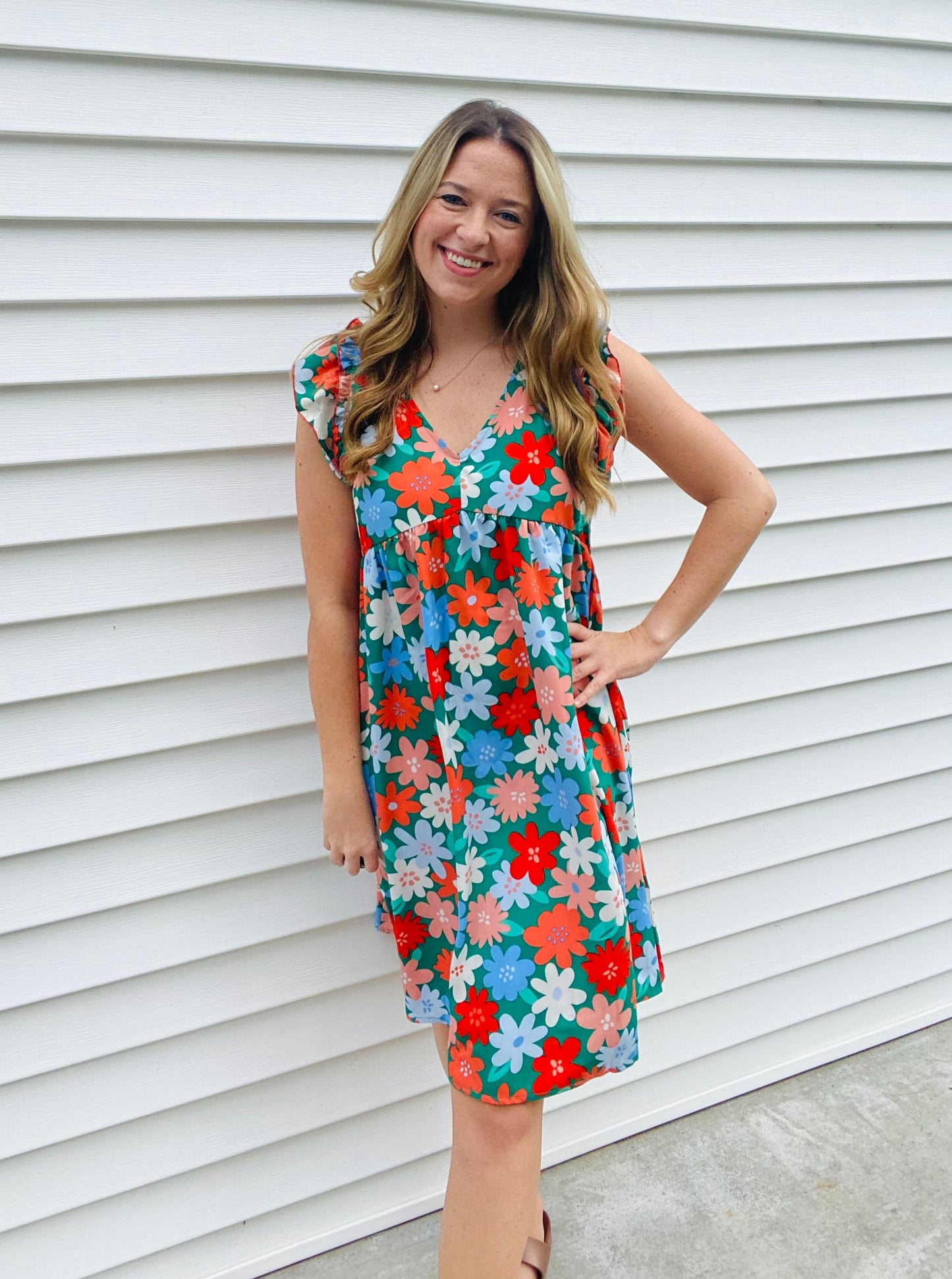 This V-neck babydoll dress flaunts a charming double frill ruffle yoke and is adorned with a multicolor floral challis print. Crafted from a lightweight woven fabric, it features modest short sleeves, side pockets, and a flattering midi length shift silhouette. A beautiful addition to your wardrobe.