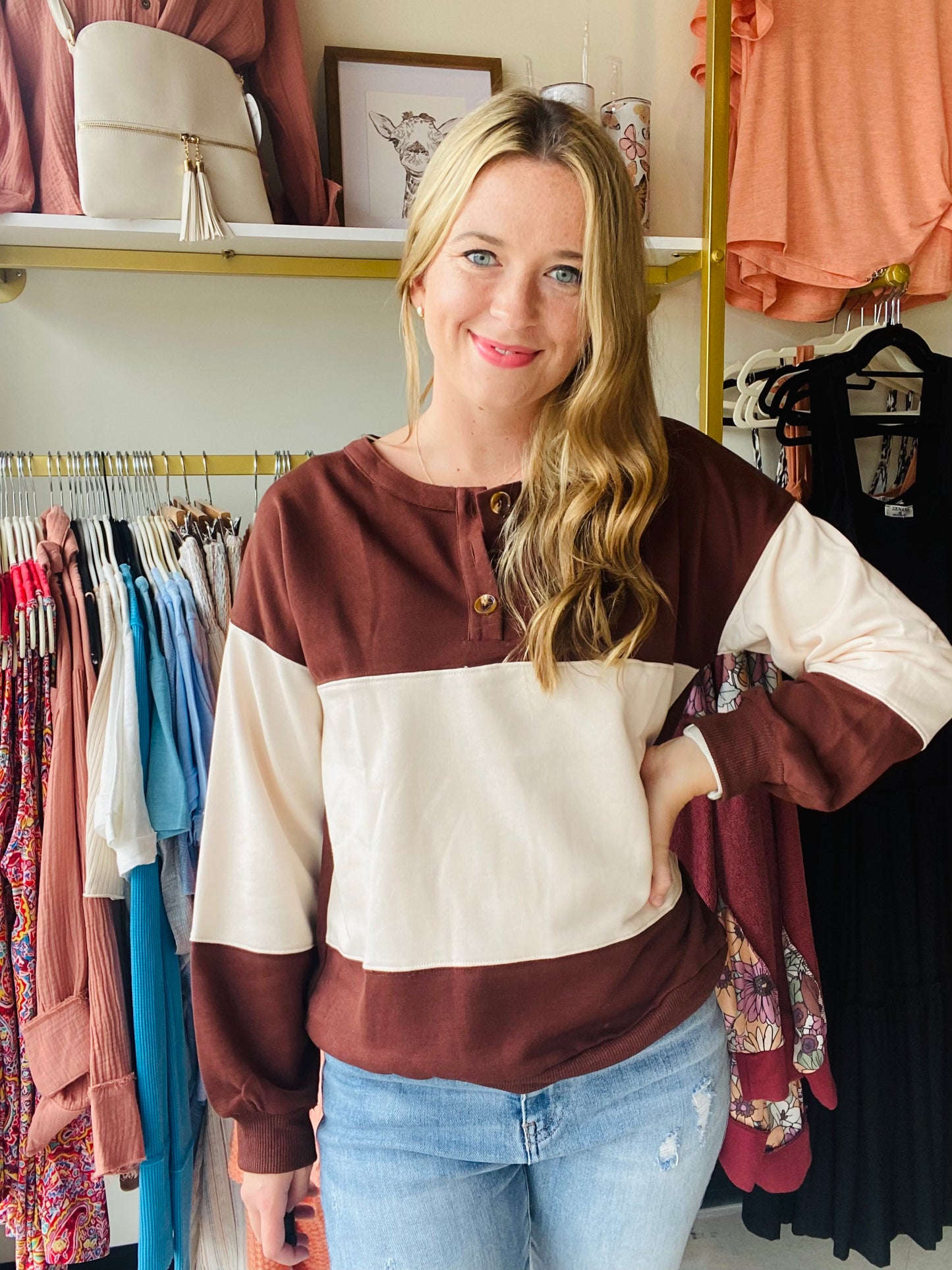 Stay warm and stylish in any season with this Khaki and Brown Colorblock Sweatshirt. Crafted from a cozy fabric and featuring a ribbed trim and round neckline, this sweatshirt is both comfortable and fashionable. The three button detail and perfect fall colors add the perfect touch to complete the look. Dress it up with denim for a casual and put-together style.