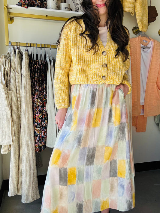 Add a pop of color to your wardrobe with our Petrichor Gathered Midi Skirt! Featuring a playful paint swatch pastel pattern and an elastic waistband for a comfortable fit. Perfectly paired with our sunshine yellow sweater and Edlin Tank for a fun, quirky look. Grab yours today and bring some sunshine to your day!
Sadie & Sage