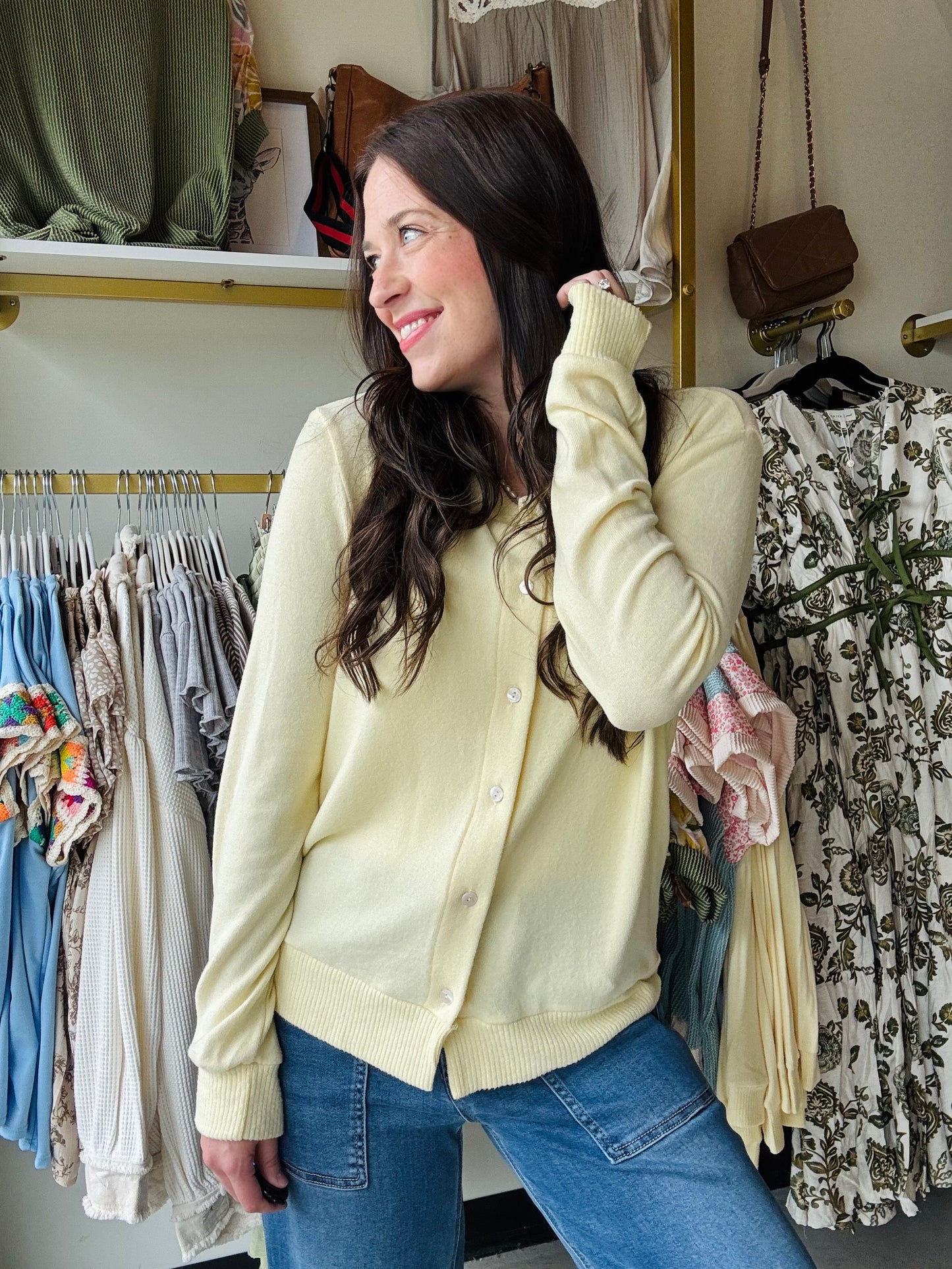 Experience comfort and style with this pastel yellow sweater cardigan, crafted from buttery soft material for a gentle touch against your skin. Featuring fully functioning front buttons, it offers versatile wear options, while ribbed cuff details add subtle texture and a refined finish. The beautiful pastel yellow hue brings a fresh, elegant pop of color to any wardrobe, perfect for layering in cooler weather.