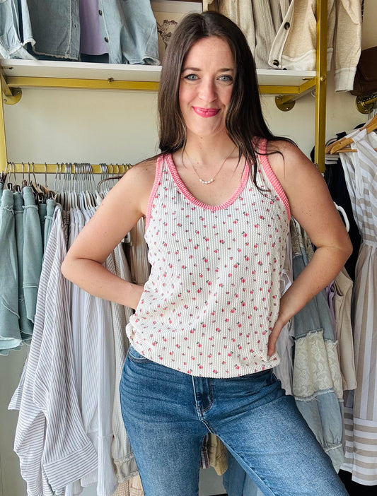 This playful Pink Contrast Floral Tank brings a fresh twist to your wardrobe with its vibrant floral print and solid rib contrast. Featuring a flattering scoop neckline, racerback design, and a curved hem, it offers a relaxed fit that moves with you. Each tank is uniquely patterned, making yours truly one of a kind. Perfect for sunny days and casual outings, it adds a fun, feminine touch to any look.