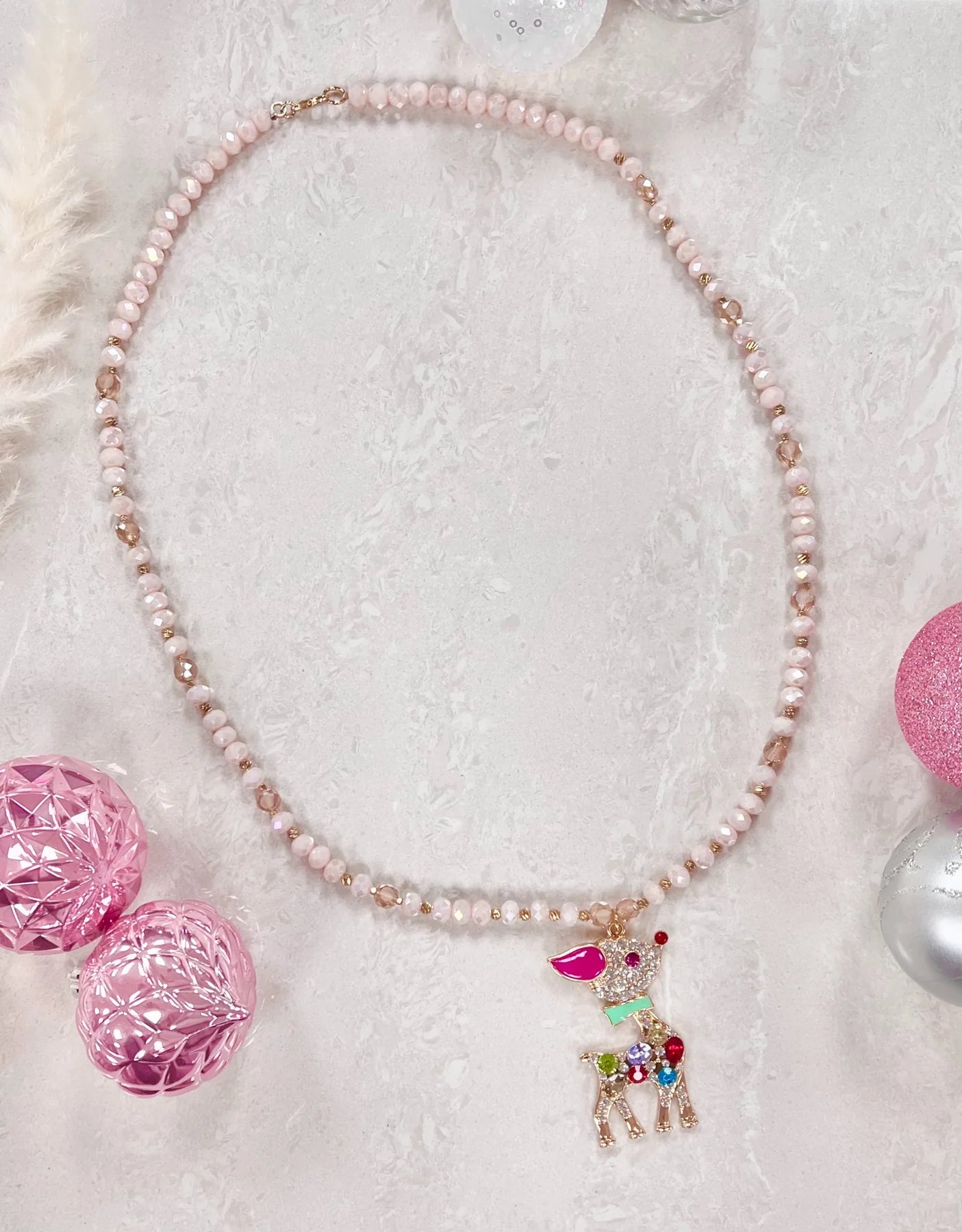 Perfect for enhancing your holiday attire or adding a touch of festive fun to your everyday look, "The Red Nose Reindeer" Beaded Necklace is a playful and delightful choice for those who love to embrace the magic of the holidays and spread cheer with their accessories.