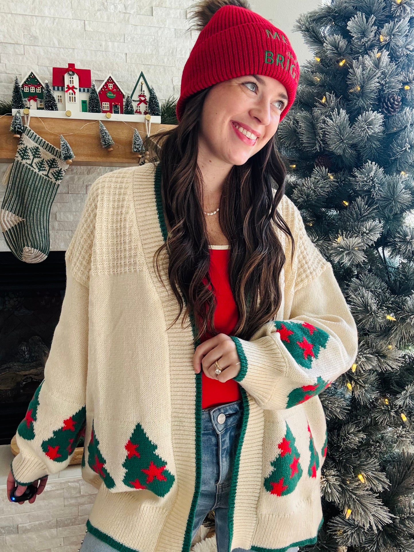 Wrap yourself in holiday cheer with this charming cream cardigan featuring festive Christmas trees adorned with twinkling stars. The playful design is elevated by crisp green trim detailing that frames the neckline and cuffs, while cozy ribbed fabric throughout adds texture and comfort. Perfect for spreading seasonal joy whether you're decorating, gathering with loved ones, or simply embracing the festive spirit in style. A wardrobe essential that brings warmth and whimsy to your holiday rotation.
Fantasti