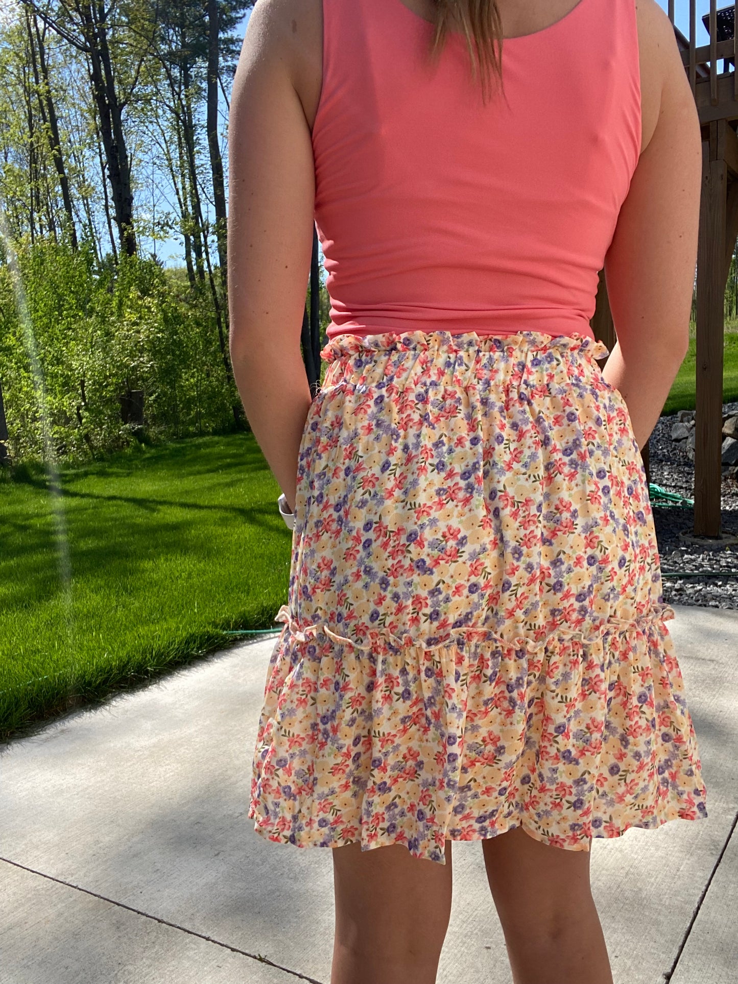 This Summer Garden Tiered Skirt is perfect for both office and leisure situations. The skirt features an elastic waist for comfort and light weight fabric for breathability and ease. With its modest length and feminine style, you can stay cool and classy throughout the day.