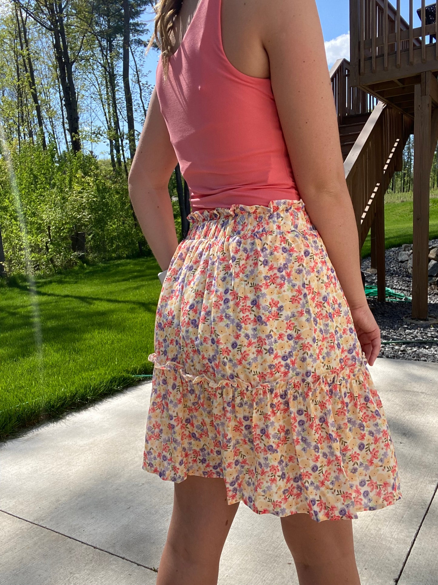 This Summer Garden Tiered Skirt is perfect for both office and leisure situations. The skirt features an elastic waist for comfort and light weight fabric for breathability and ease. With its modest length and feminine style, you can stay cool and classy throughout the day.