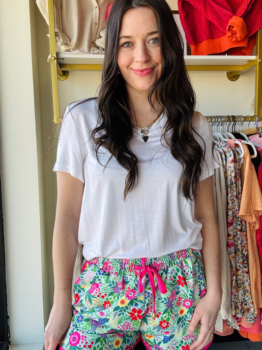 We know we're always on the lookout for a good, comfy basic! This basic tee is definitely one of those pieces! It's comfy and a perfect fit that makes it so easy to wear and the colors make styling and layering it a breeze! These top features short sleeves, a V-neck, and a rounded hemline. 