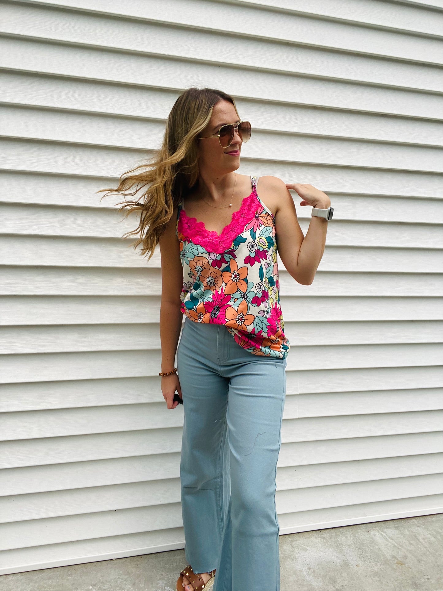 Look summer-ready in this light and flowy Vibrant Floral Lace Accent Tank. With its slightly oversized fit and beautiful hot pink lace detail and floral design, this tank is perfect for any warm-weather occasion. Enjoy the style and comfort of this timeless piece.