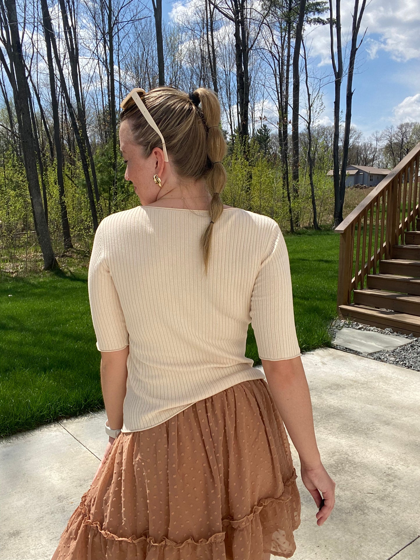This Apricot Rib Knit Half Sleeve Top easily adapts to any occasion. With its classic style and ribbed fabric, it ensures unbeatable comfort. The unique criss cross hemline provides a unique touch, while its versatile size allows for tucking or leaving it untucked. Enjoy effortless chic style.