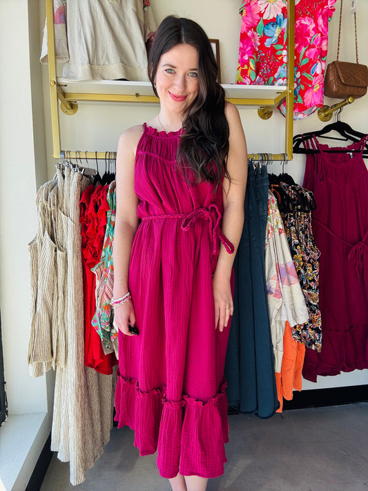 Get ready to turn heads with our Wine Braid Tie Gauze Dress! Made from soft and lightweight cotton gauze, this midi length dress features a round neck with ruffle details, an adjustable shoulder strap, and a key hole opening at the back neck. But the real showstopper? The braid waist strap tie that adds a playful touch to this elegant dress. Cheers to style and comfort!