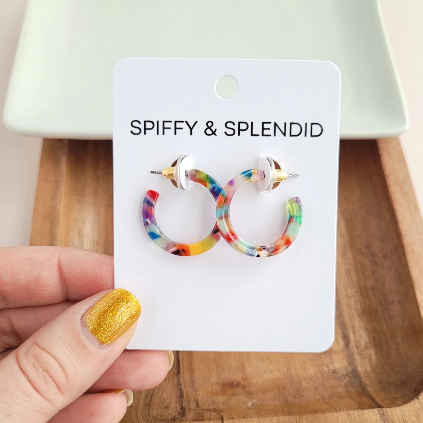 Cam is a mini sized hoop. These ultra lightweight hoops are simple and classic. The perfect versatile piece for everyday wear! Hypoallergenic stainless steel Lightweight and durable plant-based acetate acrylic 1" diameter Each pair will vary in coloring, making them perfectly unique