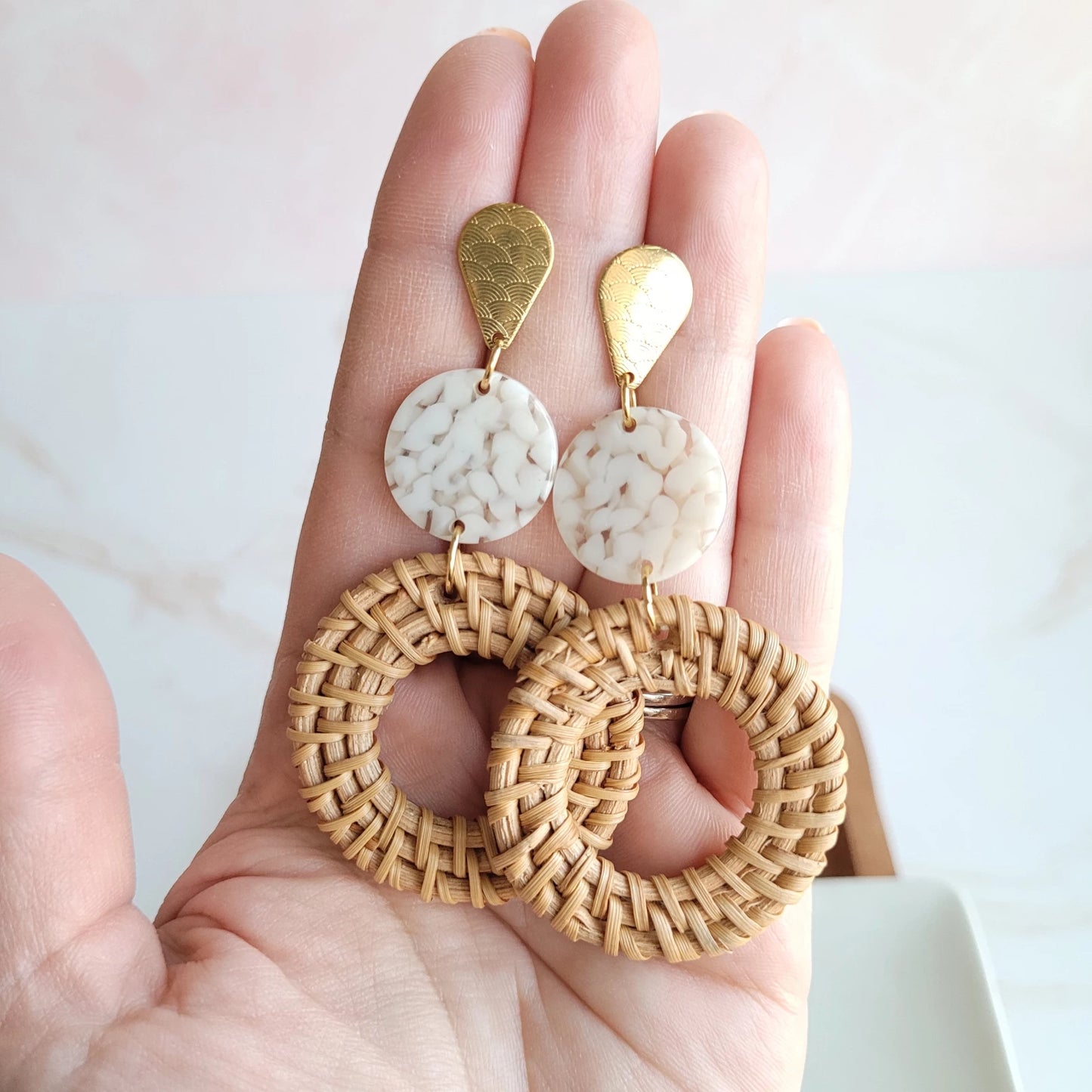 Bring a little bit of resort wear glam to your everyday style with these lightweight, rattan earrings. We've hooked you up with the perfect statement earrings with a trendy twist on our classic rattan look. The gold accents and acrylic only add to their luxurious feel and make them perfect for pairing with any outfit.