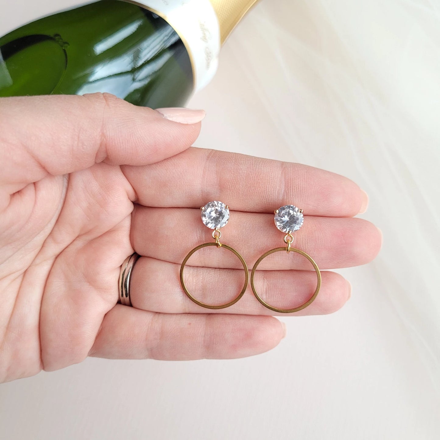 Our I Do Earrings are the cutest little earrings that look exactly like an engagement ring! These are perfect for engagement parties and beyond. Plus, bride or not, these earrings are perfect for wedding guests or just to add a formal touch to any look. Zircon stud posts on gold-plated brass 18k gold-plated stainless steel dainty loops