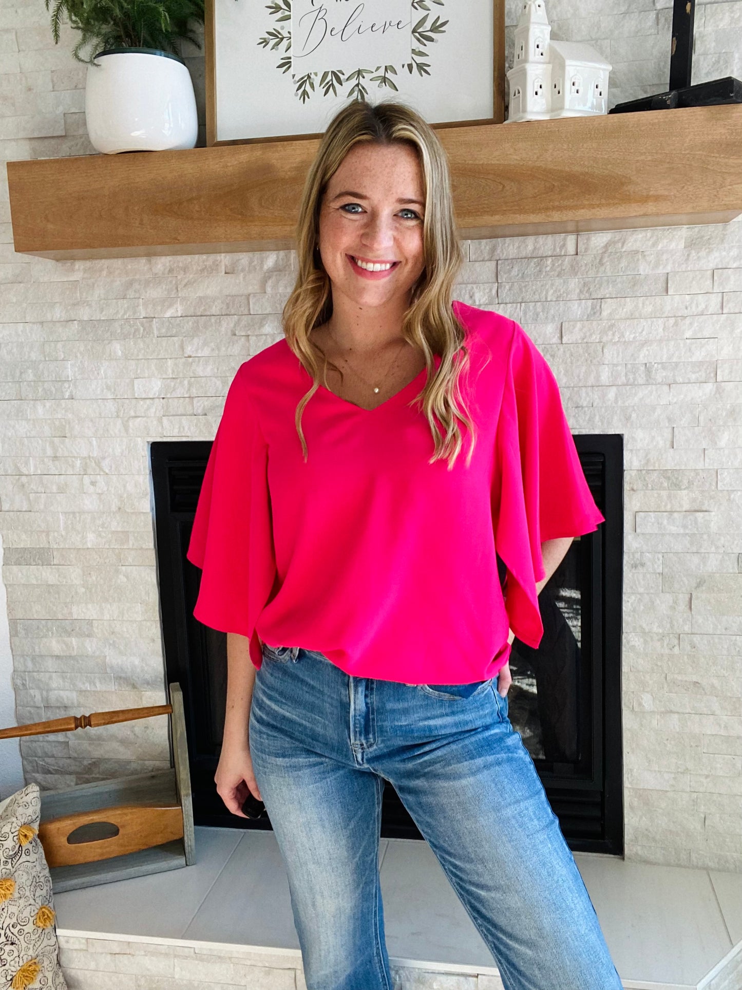 Look your best in the office this summer with the Rose Flounce Bell Sleeve Blouse. The contemporary silhouette features a distinctive bell sleeve and neon pink hue, perfect for making a statement! This style pairs effortlessly with denim and black pants, making it a versatile addition to your wardrobe. Look sharp and stay cool this season.