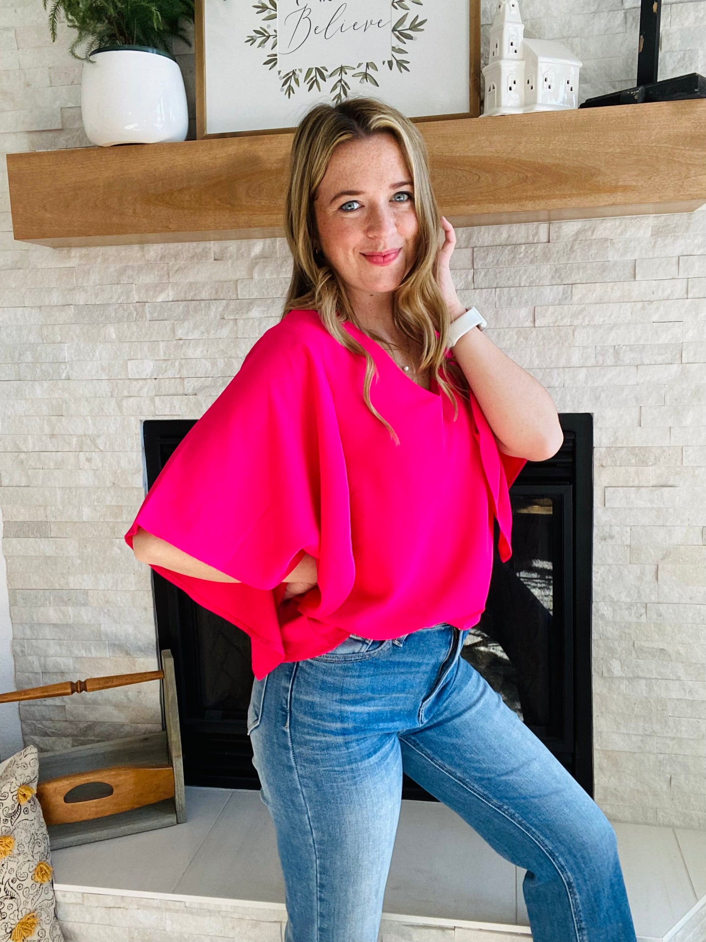 Look your best in the office this summer with the Rose Flounce Bell Sleeve Blouse. The contemporary silhouette features a distinctive bell sleeve and neon pink hue, perfect for making a statement! This style pairs effortlessly with denim and black pants, making it a versatile addition to your wardrobe. Look sharp and stay cool this season.
