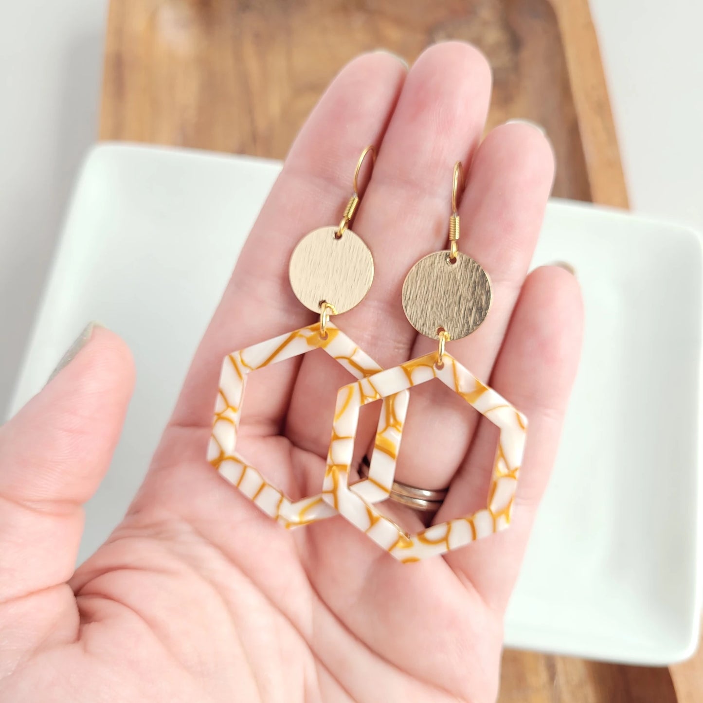Lennox is a fun style with cut-out hexagon charms paired perfectly with gold accents. 18k gold-plated hypoallergenic stainless steel hooks Gold-plated brushed brass charms Lightweight and durable plant-based acetate acrylic charms in pumpkin spice