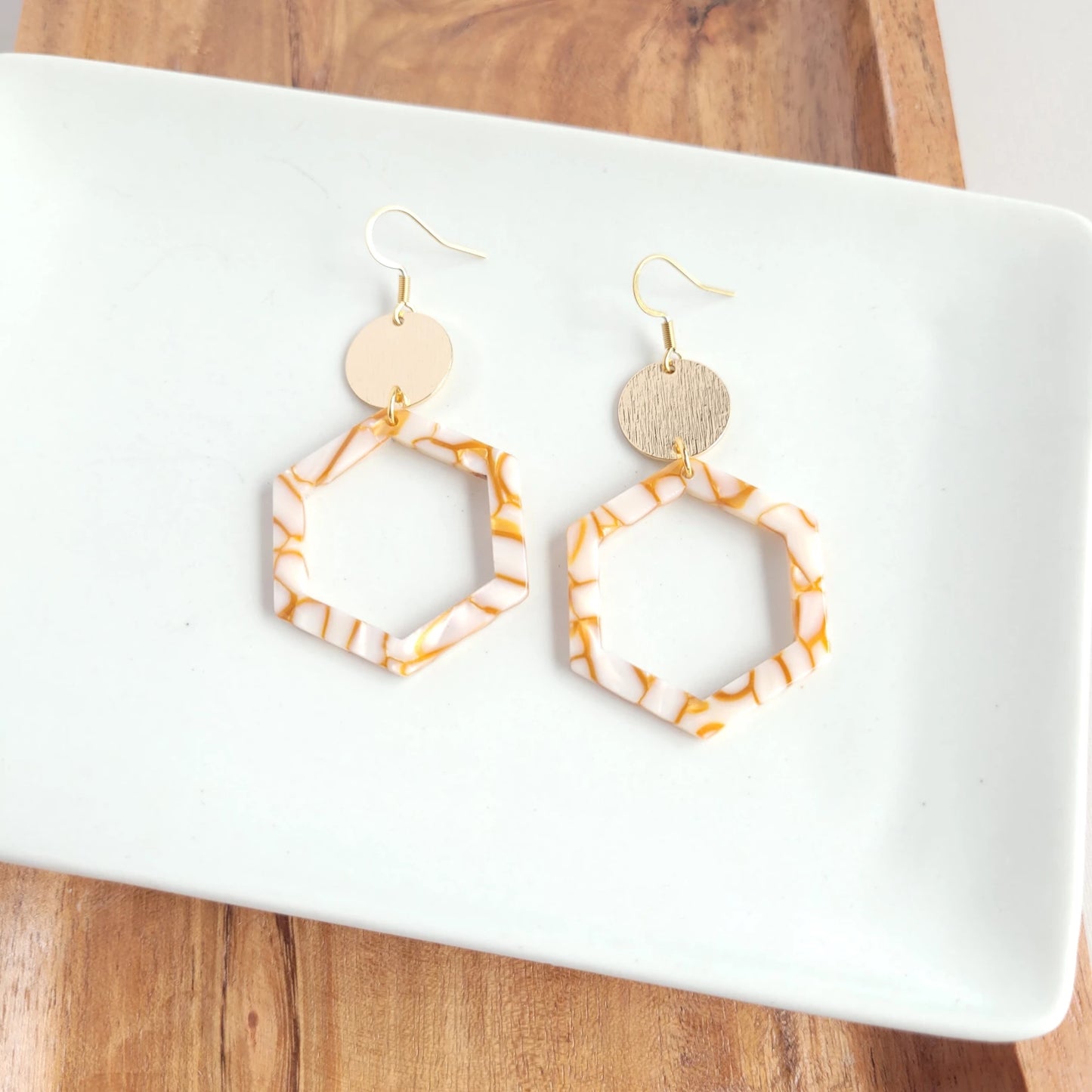 Lennox is a fun style with cut-out hexagon charms paired perfectly with gold accents. 18k gold-plated hypoallergenic stainless steel hooks Gold-plated brushed brass charms Lightweight and durable plant-based acetate acrylic charms in pumpkin spice