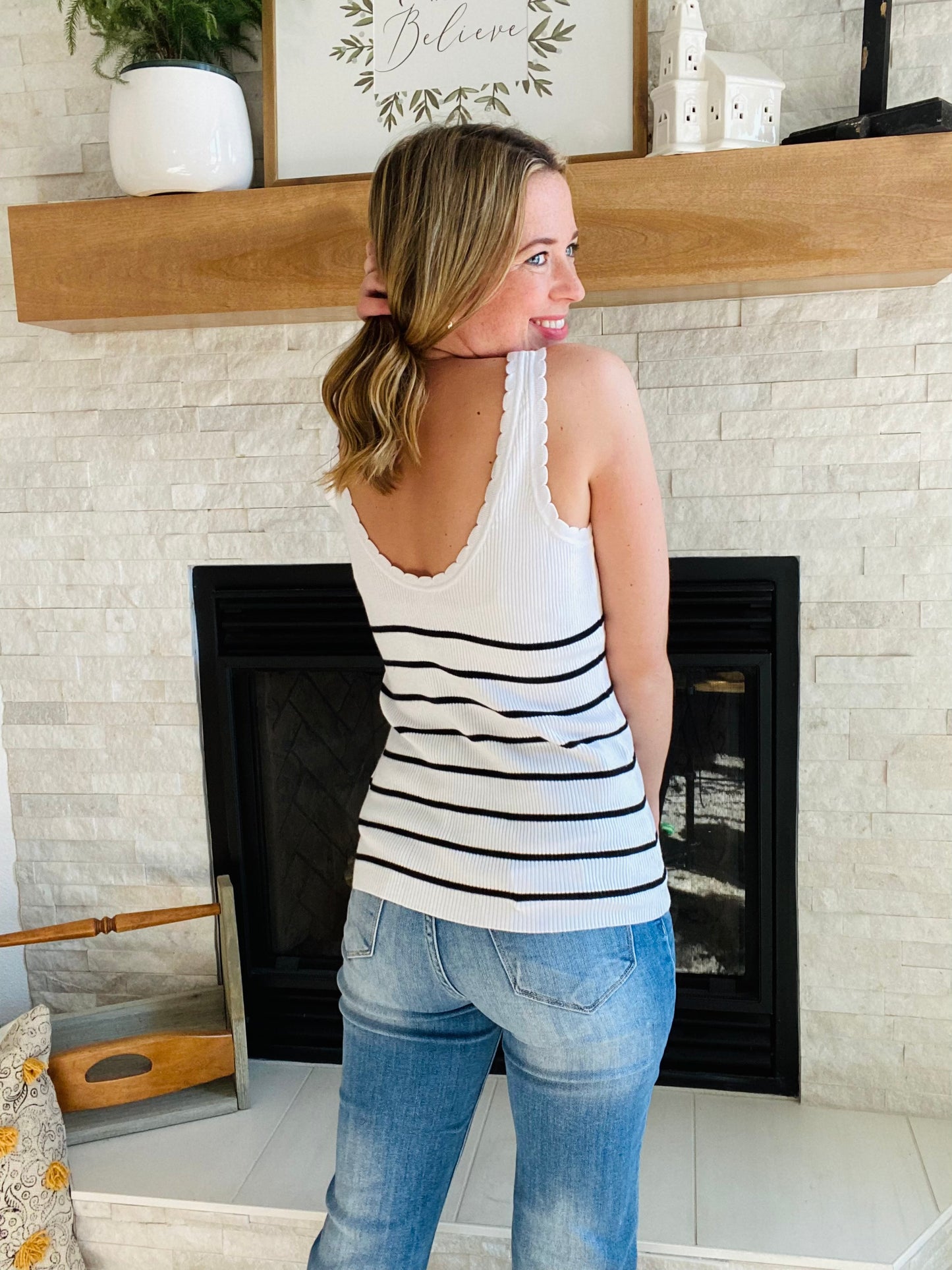 Stay cool this summer with this White Shell Rib Knit Tank Top. This tank top is designed with a rib knit and scalloped detail trim for a comfortable and stylish look. The black stripes are very classic and match almost every bottom. It also features a functional button detail to complete the look. The fabric is lightweight, breathable and perfect for hot summer days.