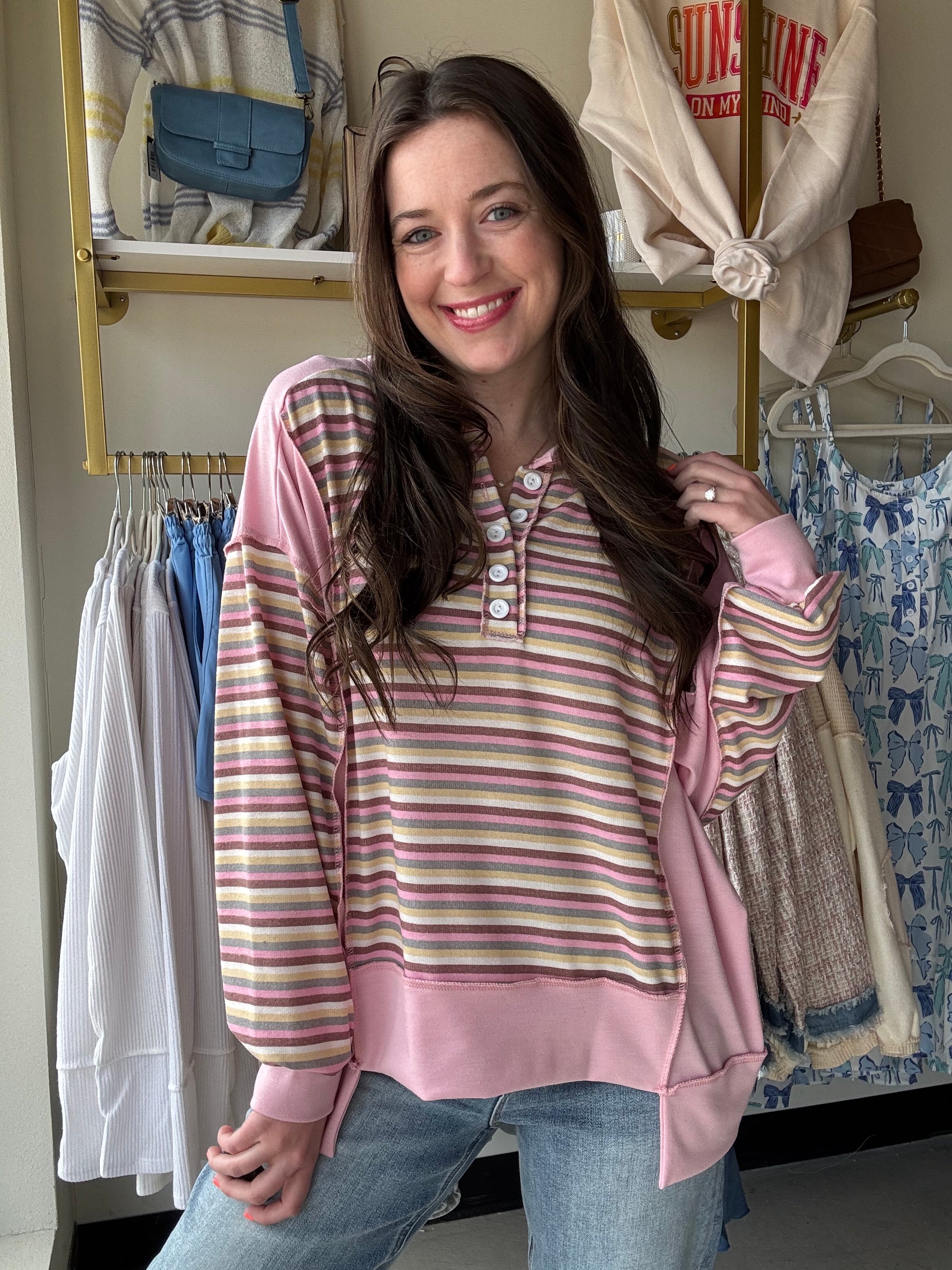 Get ready to elevate your wardrobe with our Pink Stripe Button Front Top! Featuring a playful blend of colorful stripes and edgy exposed seams with raw edge details, this top is perfect for any occasion. The relaxed fit and hi-low detail provide ultimate comfort and style, while the button front and drop shoulder add a touch of uniqueness. Don't miss out on this must-have addition to your collection!