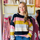 This Mustard and Mauve Striped Sweater is perfect for Fall and Winter 2023. The trendy color palette and comfortable crewneck fit mean you can style this sweater with anything. The warm acrylic fabric pairs easily with both black pants for work and denim for an everyday look.