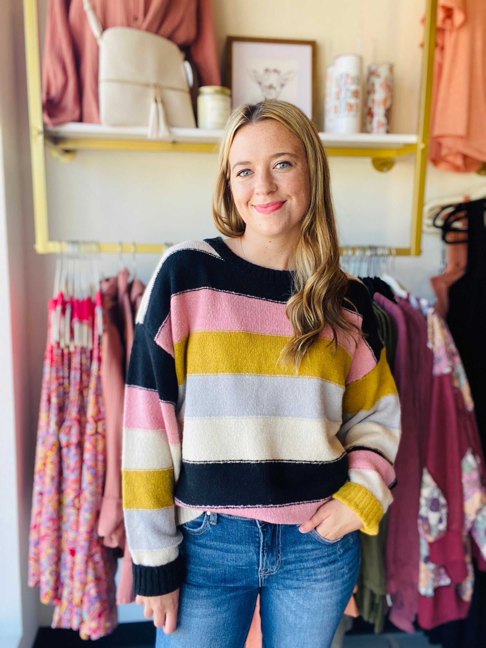 This Mustard and Mauve Striped Sweater is perfect for Fall and Winter 2023. The trendy color palette and comfortable crewneck fit mean you can style this sweater with anything. The warm acrylic fabric pairs easily with both black pants for work and denim for an everyday look.