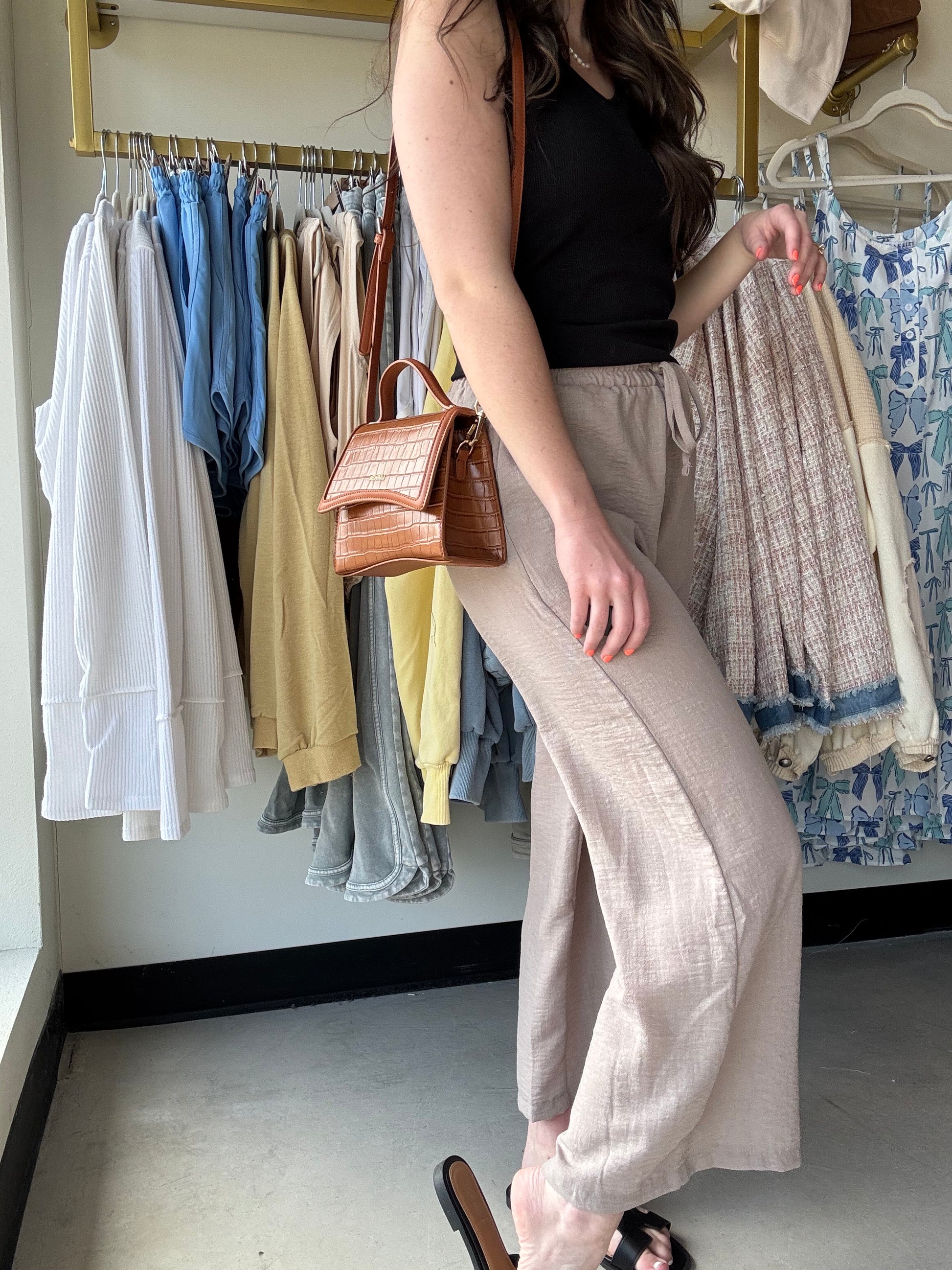 These Mocha Woven Wide Leg Pants are a stylish and comfortable addition to any wardrobe. Made with high quality woven crepe fabric, they feature an elastic band waist and drawstring waistband for a perfect fit. The side pockets add convenience and functionality to these cropped pants. Perfect for any casual or dressy occasion!