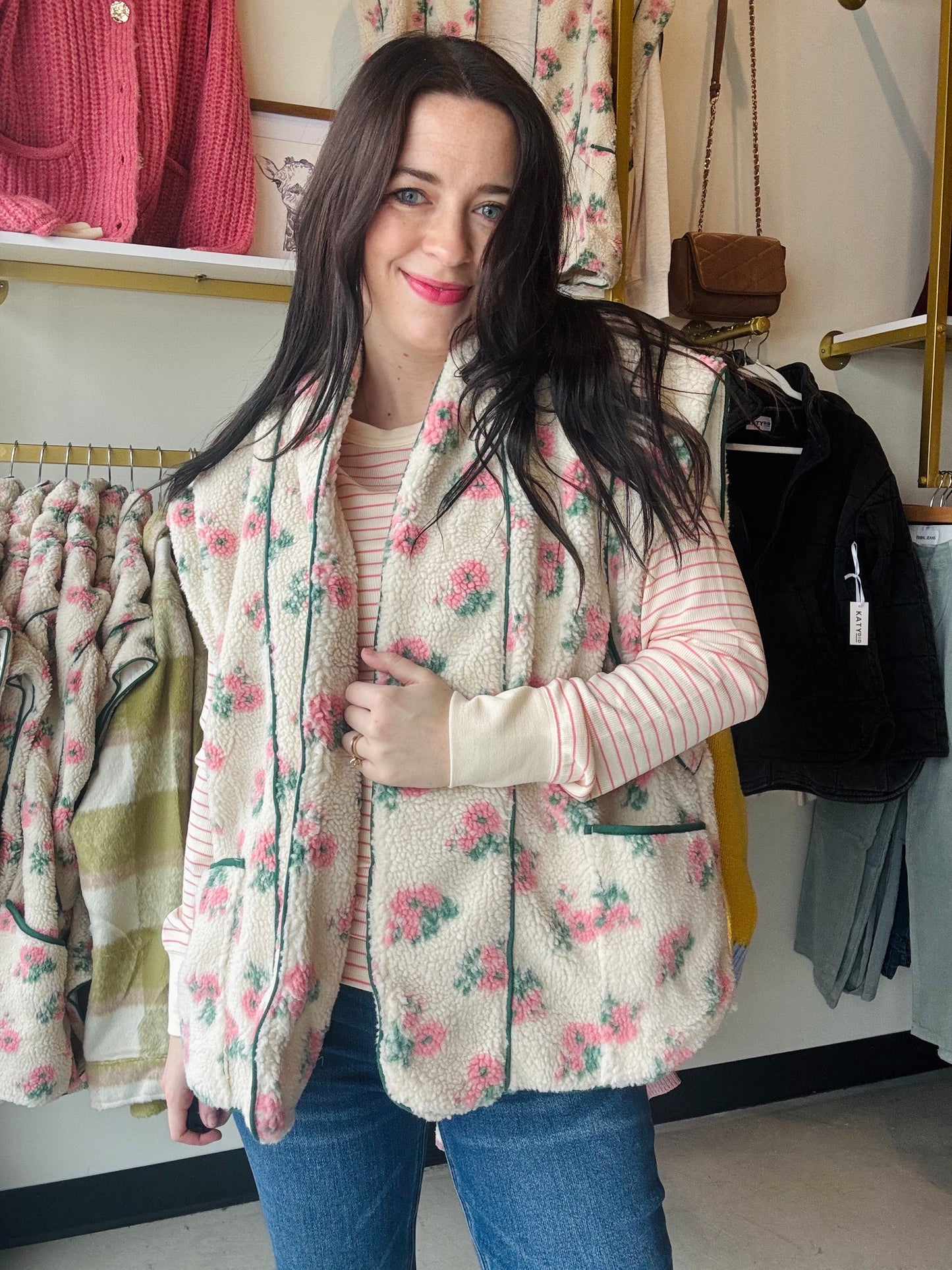 Dainty pink floral fleece vest over a pink and white striped long sleeve shirt