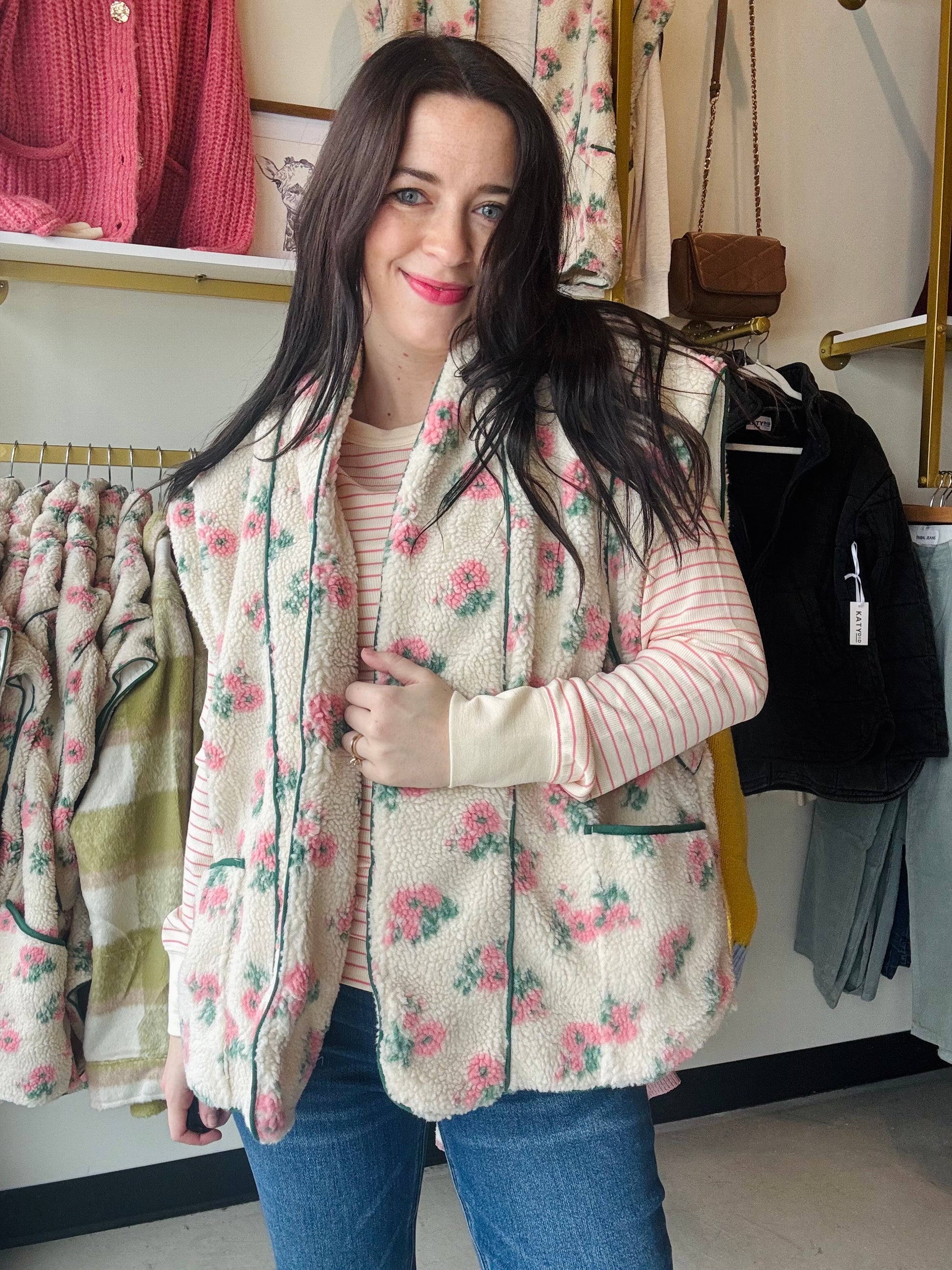 Dainty pink floral fleece vest over a pink and white striped long sleeve shirt
