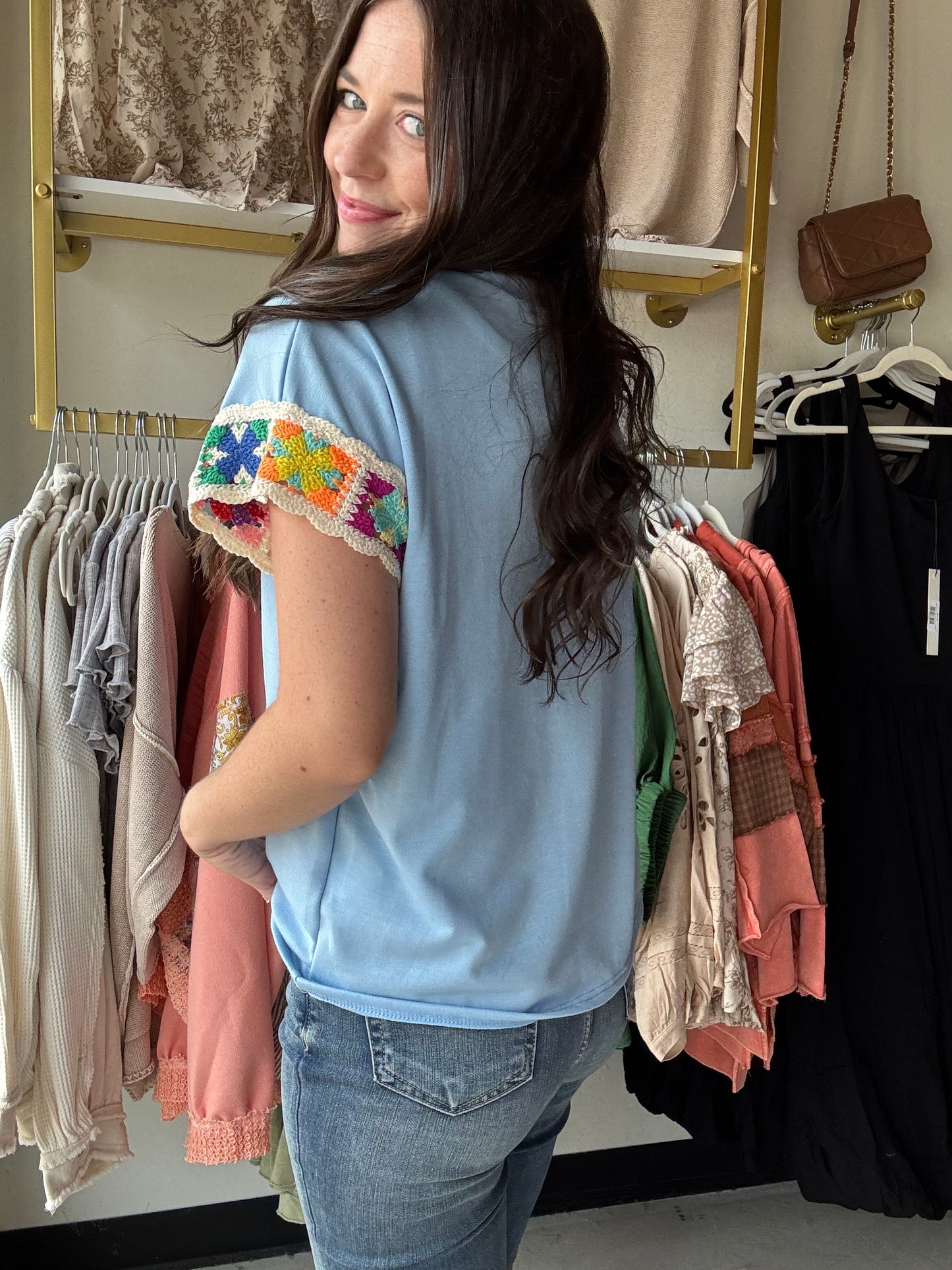 Crafted from lightweight French terry, the Light Blue Embroidered Sleeve Top offers both comfort and refined style. Its classic crew neck pairs seamlessly with batwing sleeves, which are accented by a delicate floral crochet detail at the edges. This subtle embellishment elevates the design, making it a versatile piece that combines timeless elegance with a distinctive touch. 