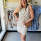 Tan & white tank sweater paired with a khaki skirt and tan purse