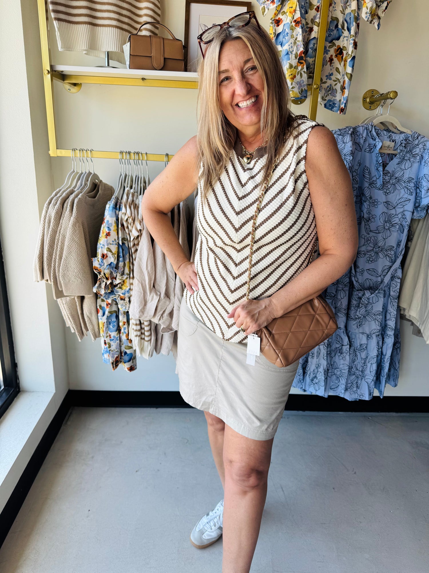 Tan & white tank sweater paired with a khaki skirt and tan purse