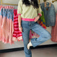 Green & hot pink striped top with boot leg mid-rise denim jeans